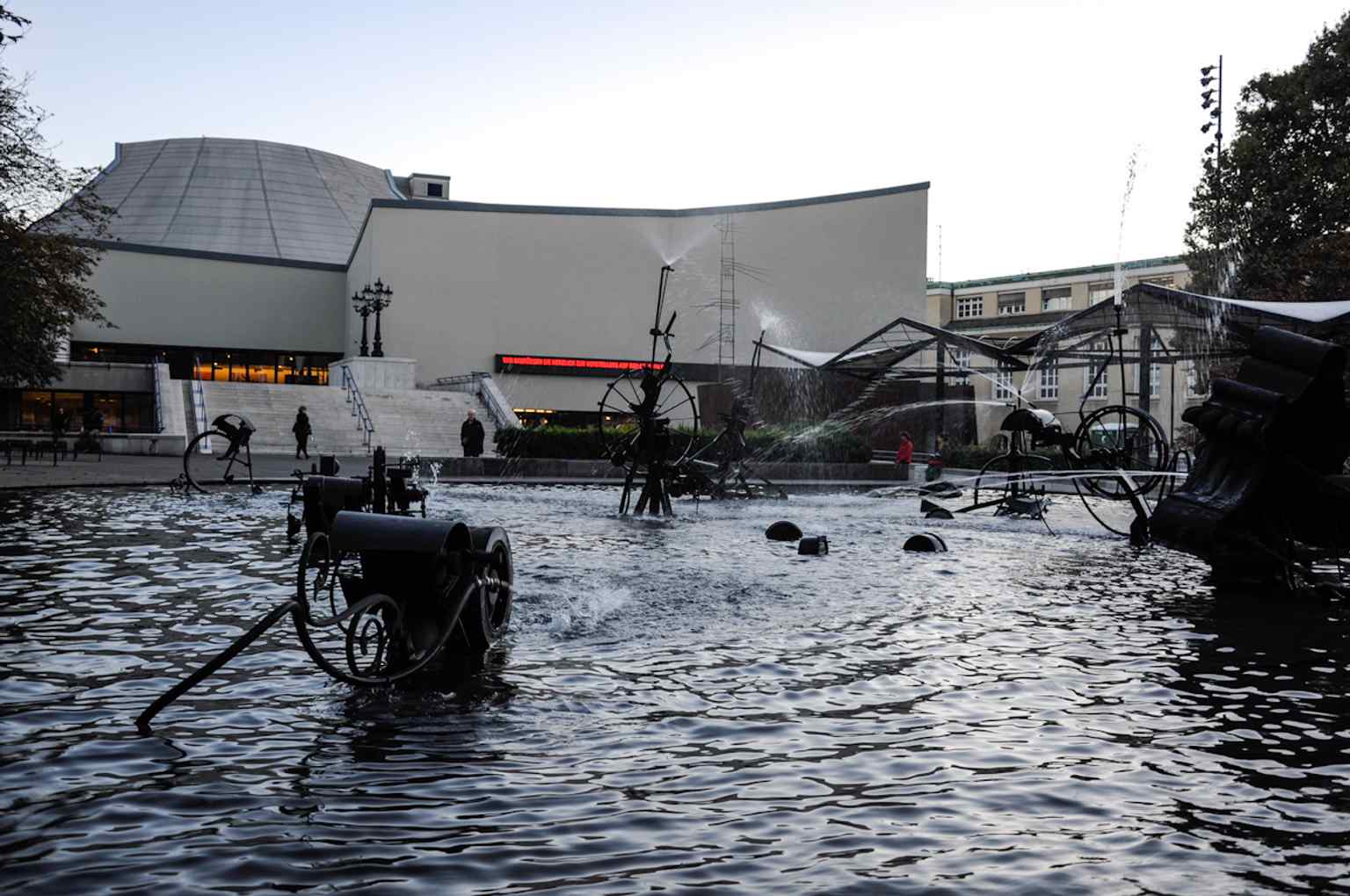 The fountain in front of Basel’s Stadttheater, matching Tinguely’s deliberate protest against the theatre’s heavy new building.