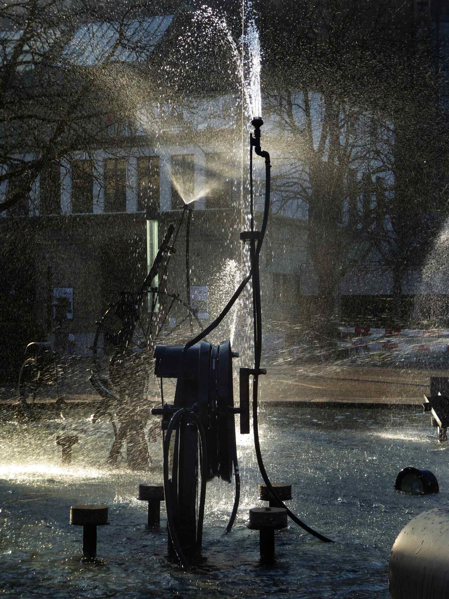 A clear artwork-style view of the fountain’s playful machinery, echoing Tinguely’s long connection to Basel Fasnacht.