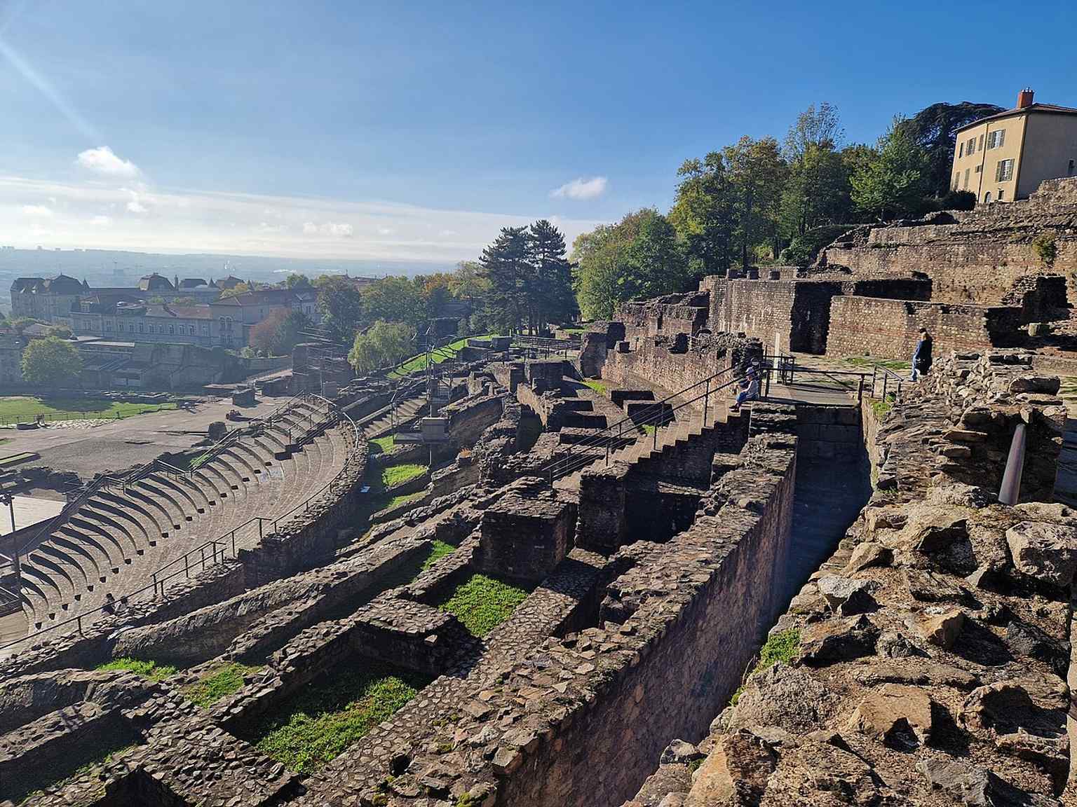 The upper seating area and surviving cavea, where the theatre’s curved rows of seats and restored circulation spaces are still visible.