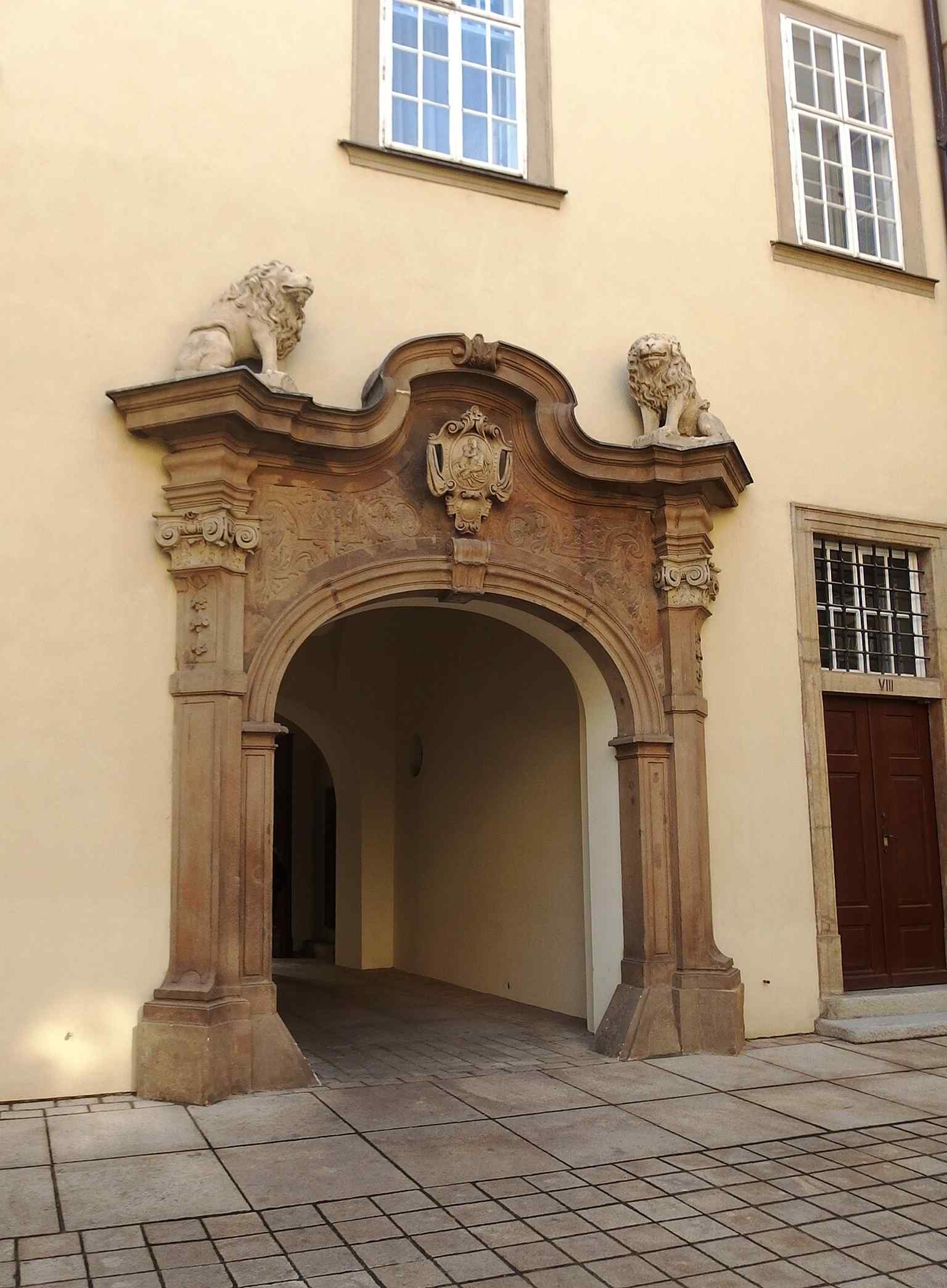 A close view of one of the ornate portals reused in the building — a reminder that the complex absorbed Renaissance and Baroque fragments from older Brno houses.