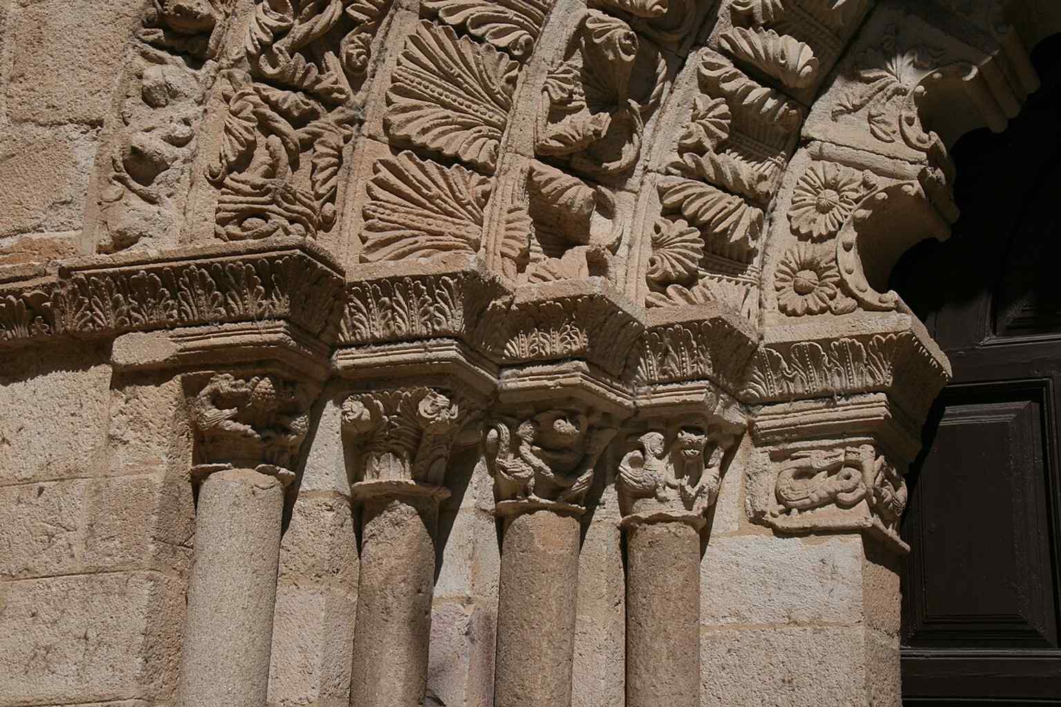 A carved impost from the doorway, one of the small Romanesque details that survived centuries of worship and weather.