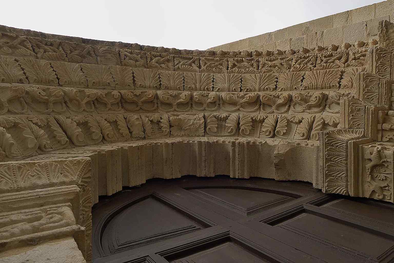 Close-up of the portal’s arch mouldings, a good view of the sculpted detail that inspired local superstition.