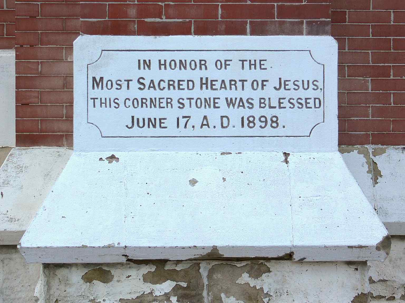 The 1898 cornerstone, laid at the start of construction before the church was dedicated in 1902.