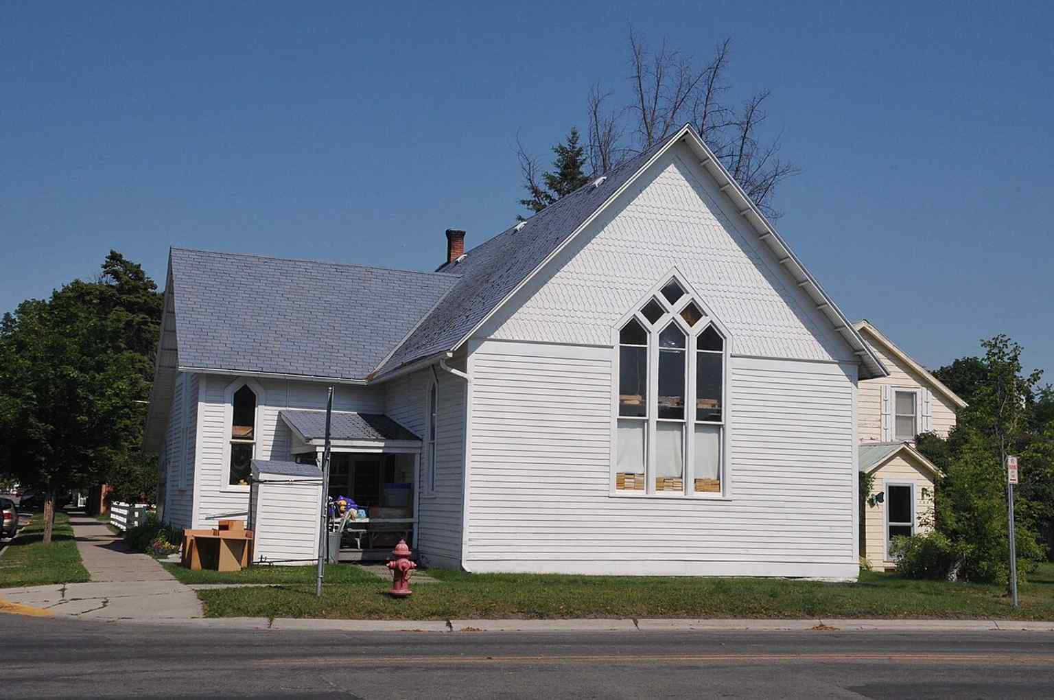 The former Scandinavian Methodist Church in Kalispell, later reused as a thrift store, showing the simple wood-frame building that began life serving the Scandinavian congregation in 1895.