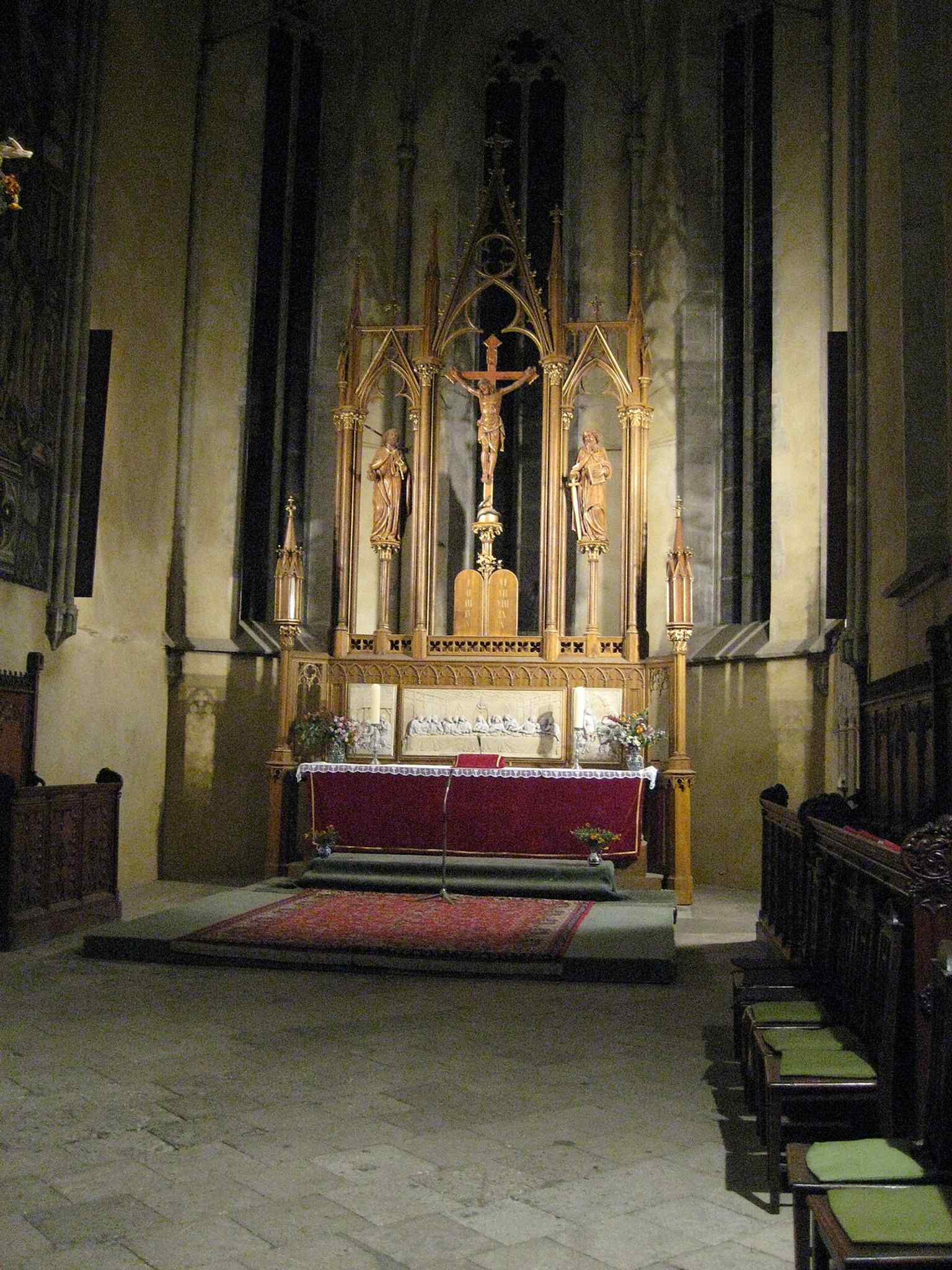 Gaze upon the Gothic interior of the cathedral, leading towards the main altar, a central piece of the church's spiritual life.
