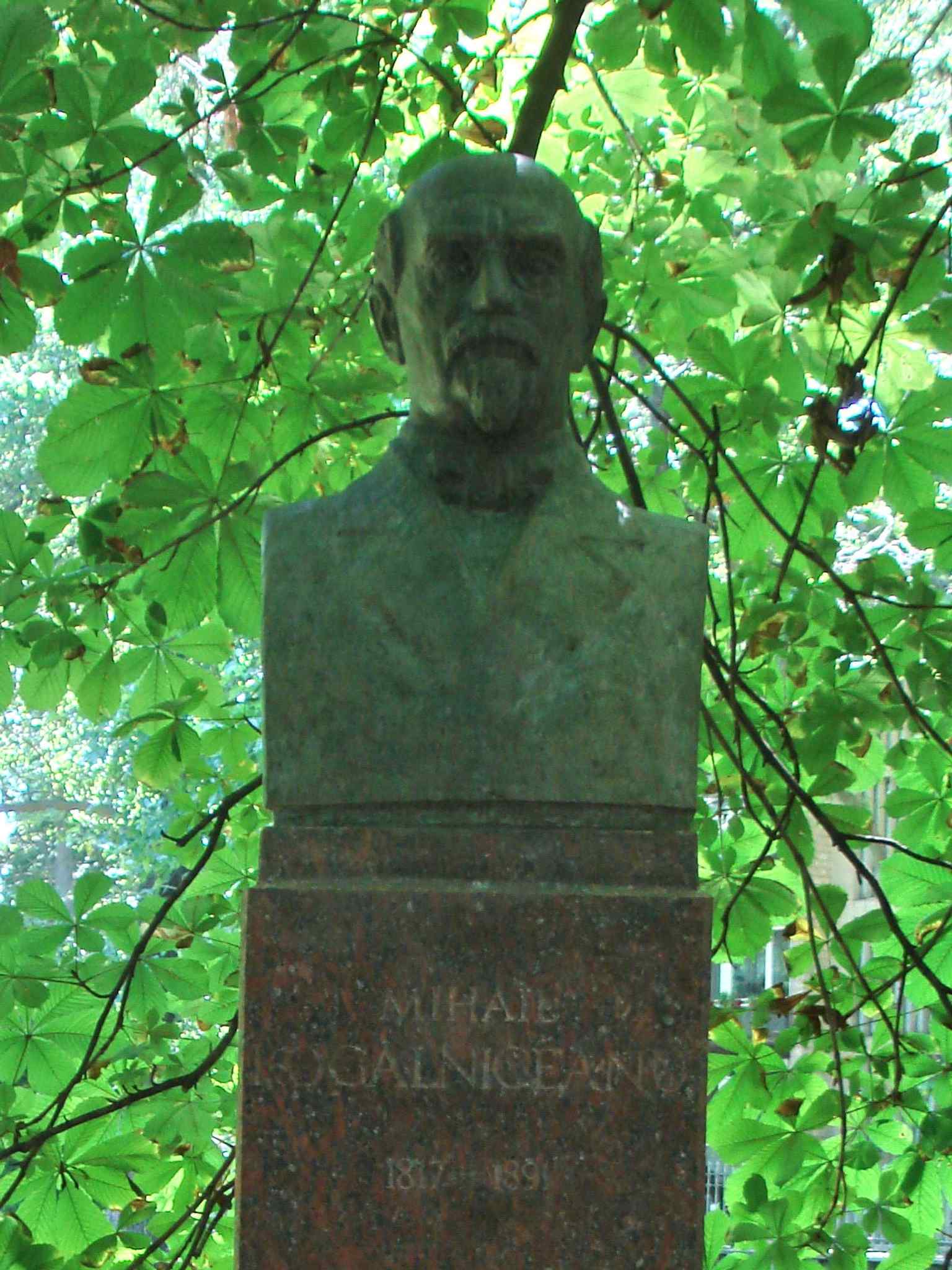 A close look at one of the red granite busts — the alley originally opened with 12 busts before later additions expanded it.