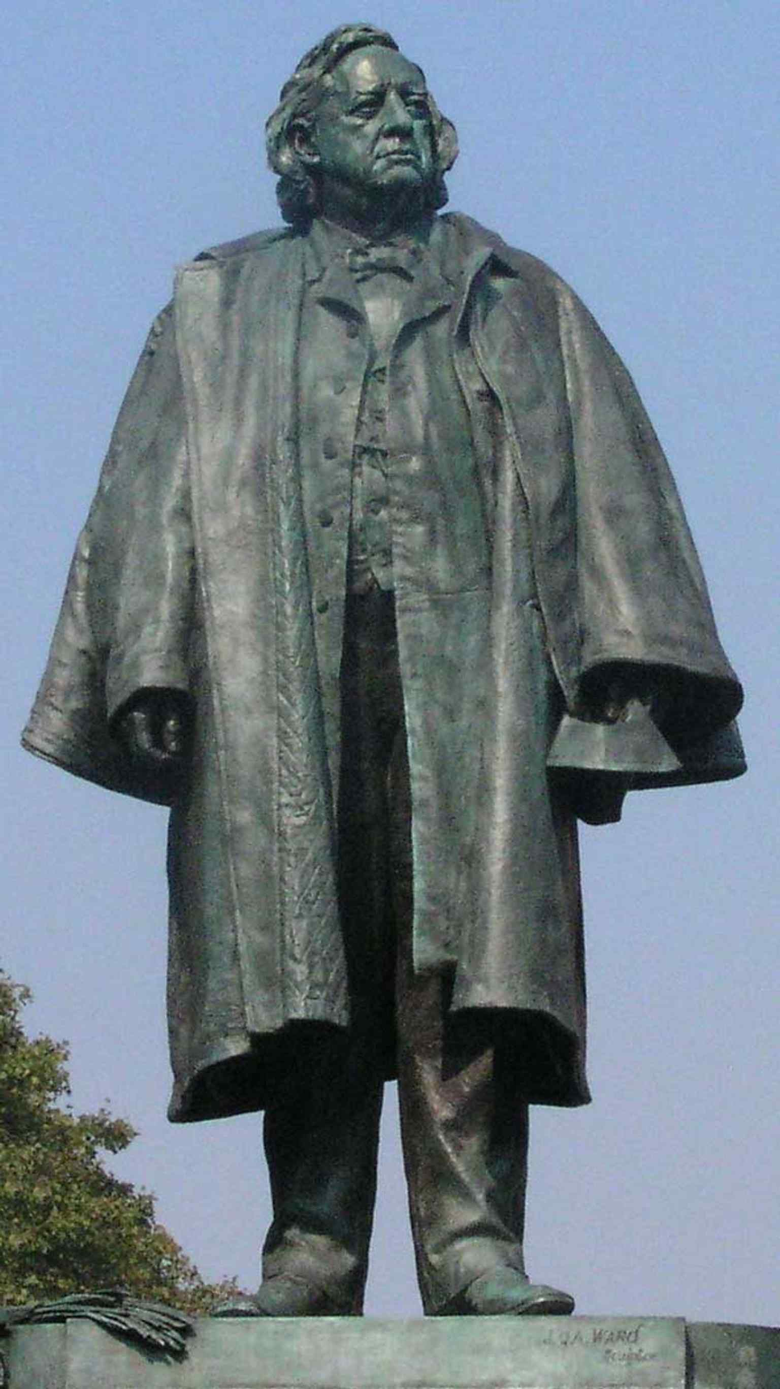 An exterior view of Henry Ward Beecher's statue, focusing on his main figure, which was created as a conscious effort to restore his public legacy after a major scandal.