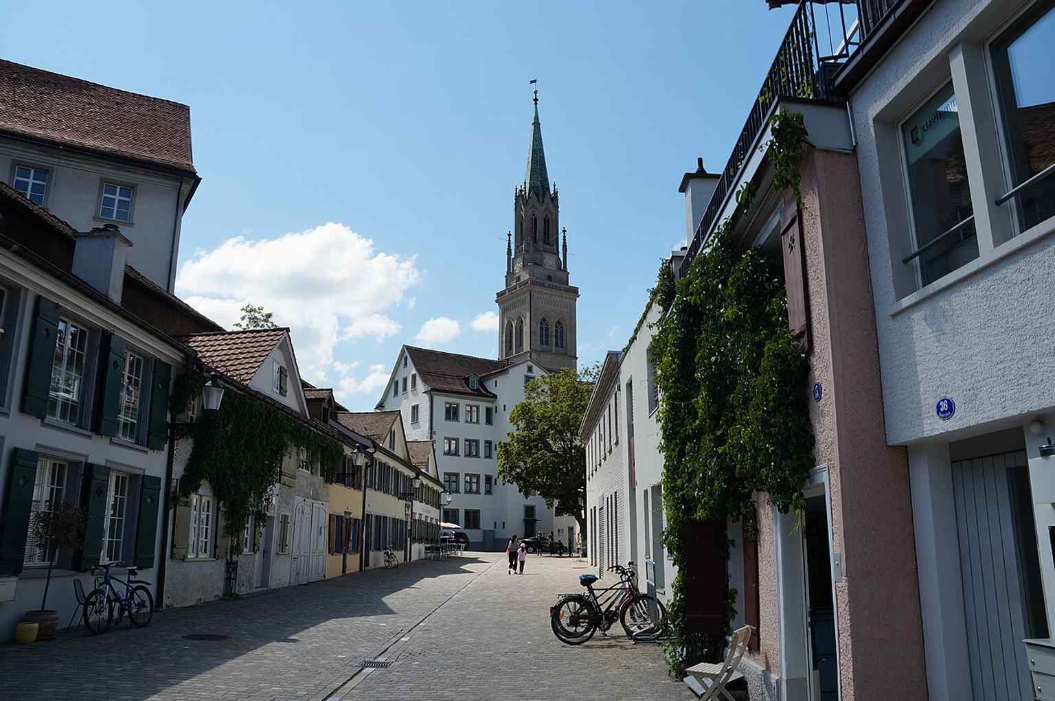 Another strong exterior angle showing the church’s tower and stepped façade details, including the rebuilt upper tower finished in a neo-Gothic style.
