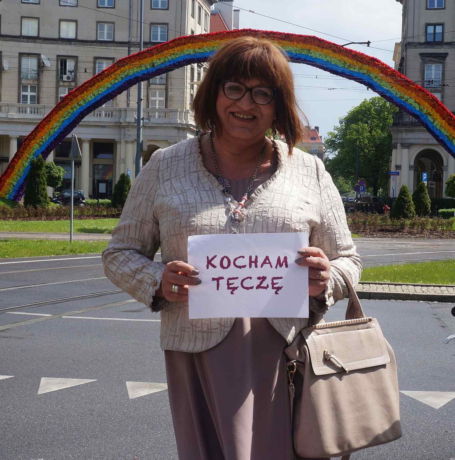 Anna Grodzka standing under the Rainbow in 2014, highlighting how the site became linked to LGBT visibility and support.