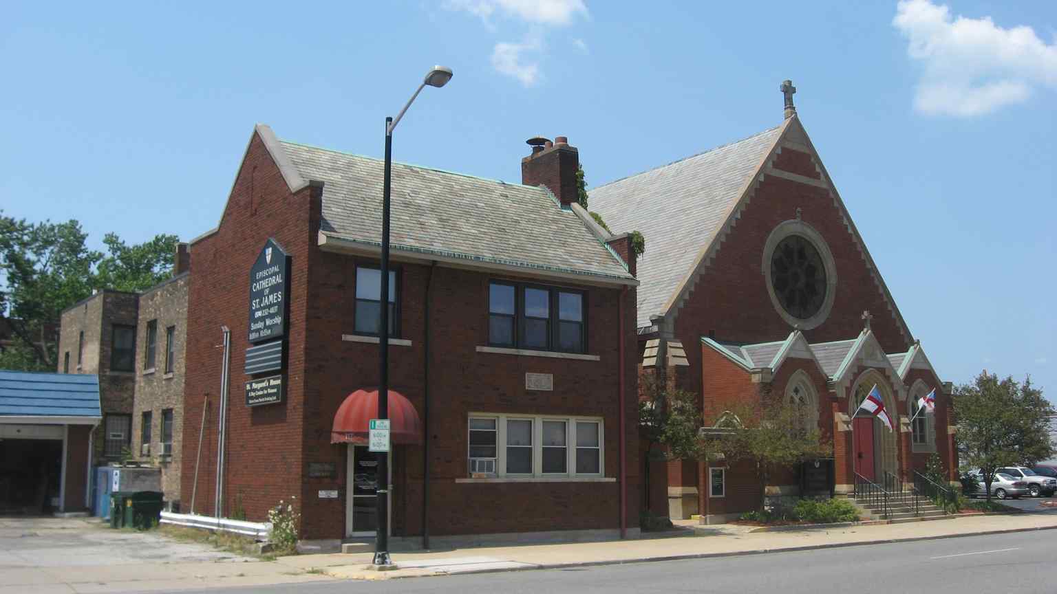 The exterior of the Cathedral of St. James, completed in 1894 in Gothic Revival style, along with its parish hall. Both structures were placed on the National Register of Historic Places in 1985.