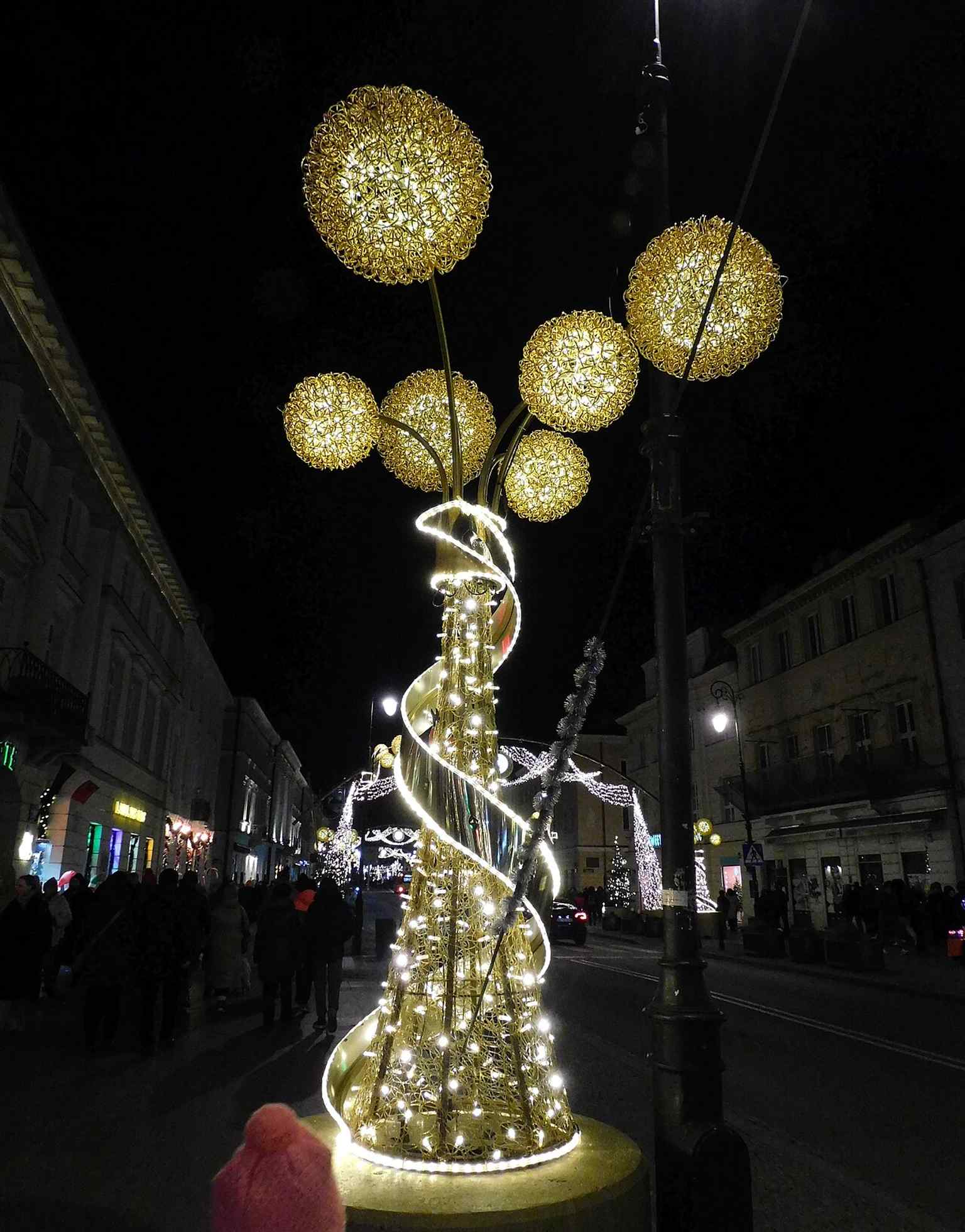 Christmas decorations on Nowy Świat, showing how the avenue now functions as a seasonal pedestrian space filled with light and activity.