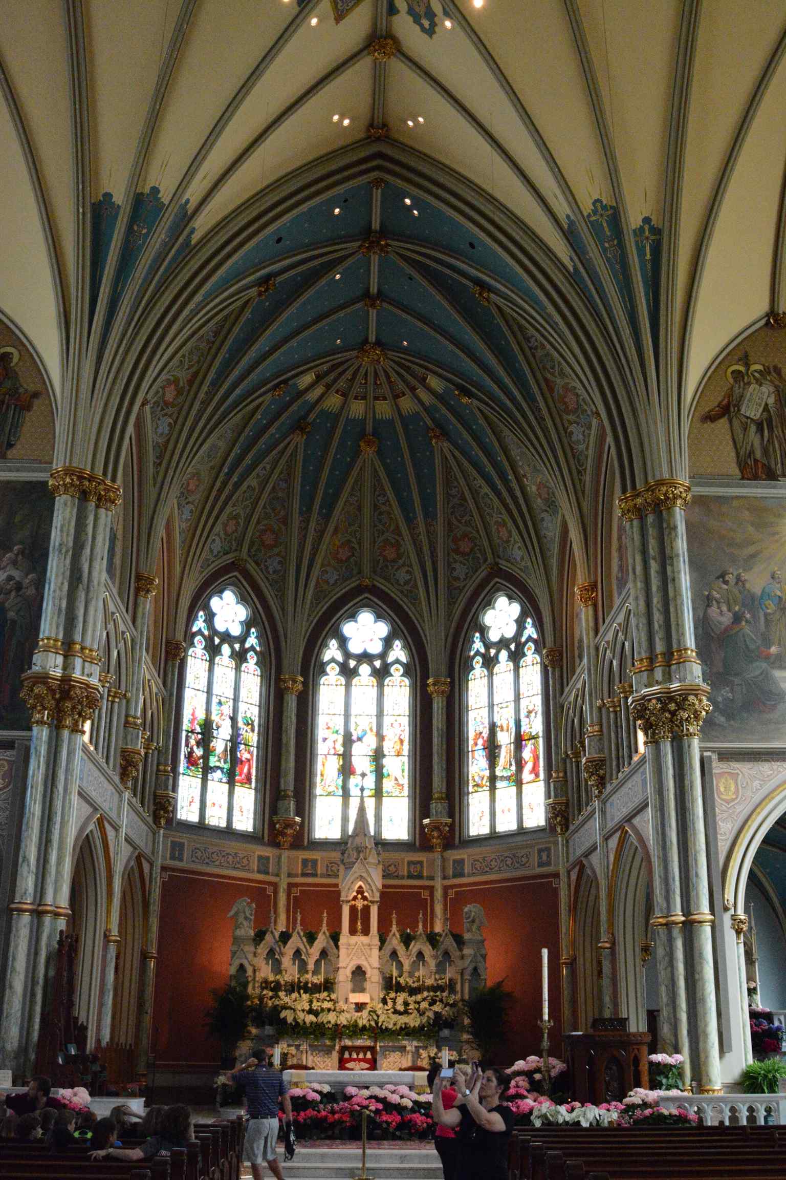 An alternate view of the spacious interior, showcasing the vibrant light filtering through the numerous stained glass windows.