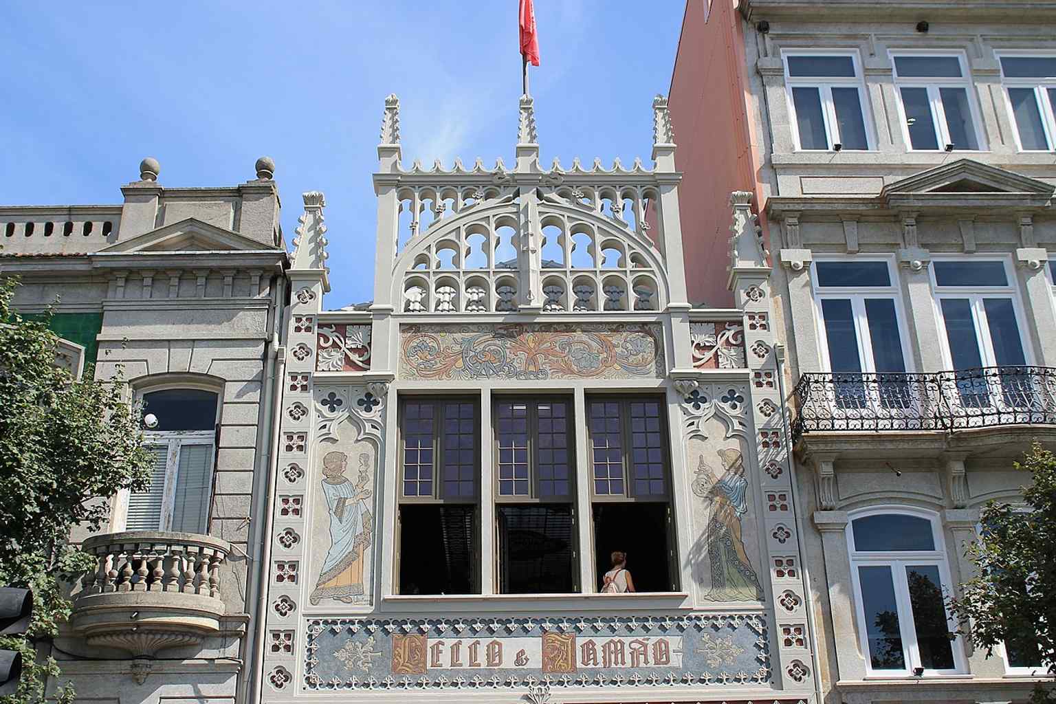 A clear street-level view of the bookstore’s ornate frontage, with the arched entrance and decorative stonework that define its historic character.