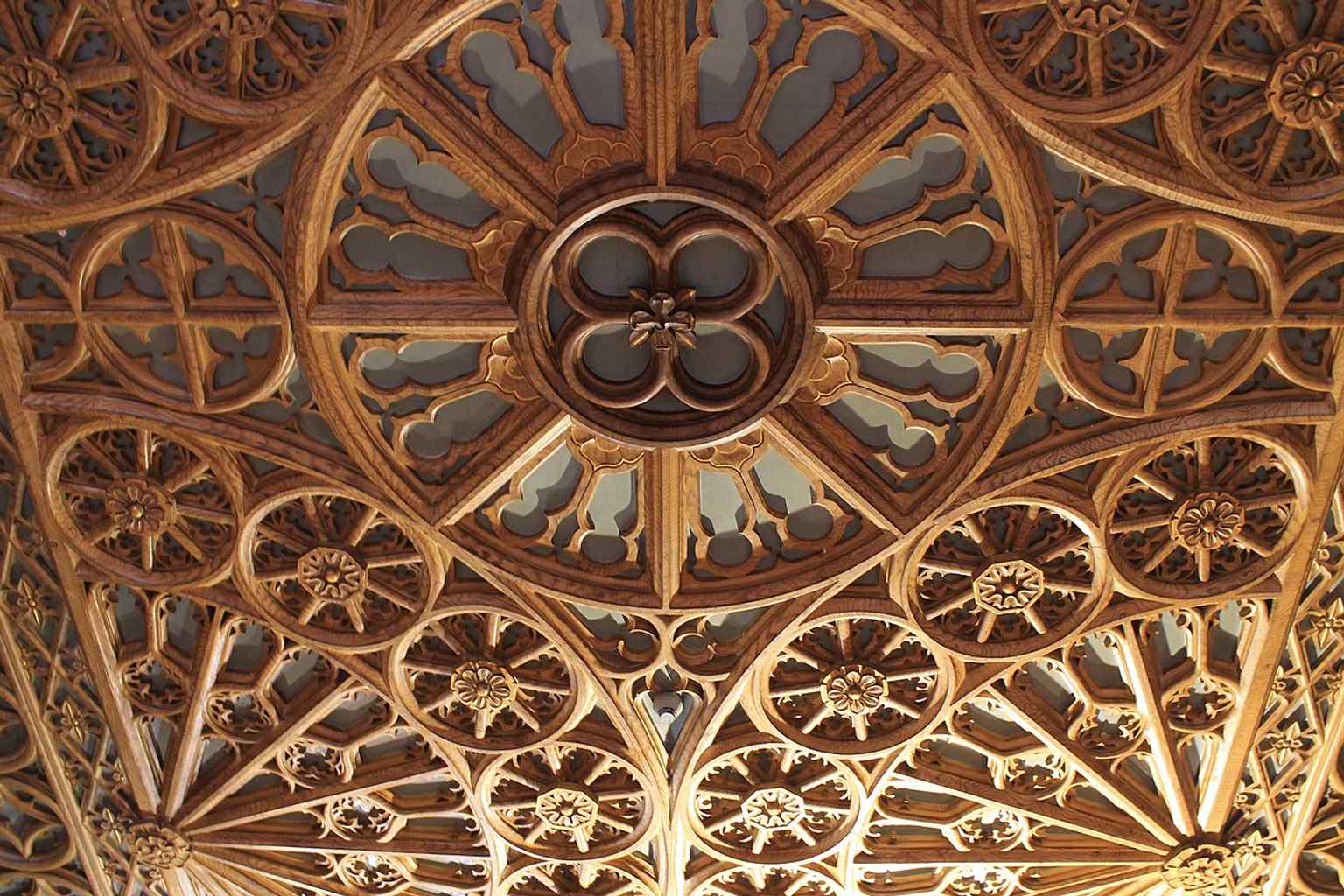 Wood-carved interior ornamentation that highlights the fine decorative work mentioned in descriptions of the bookstore’s architecture.