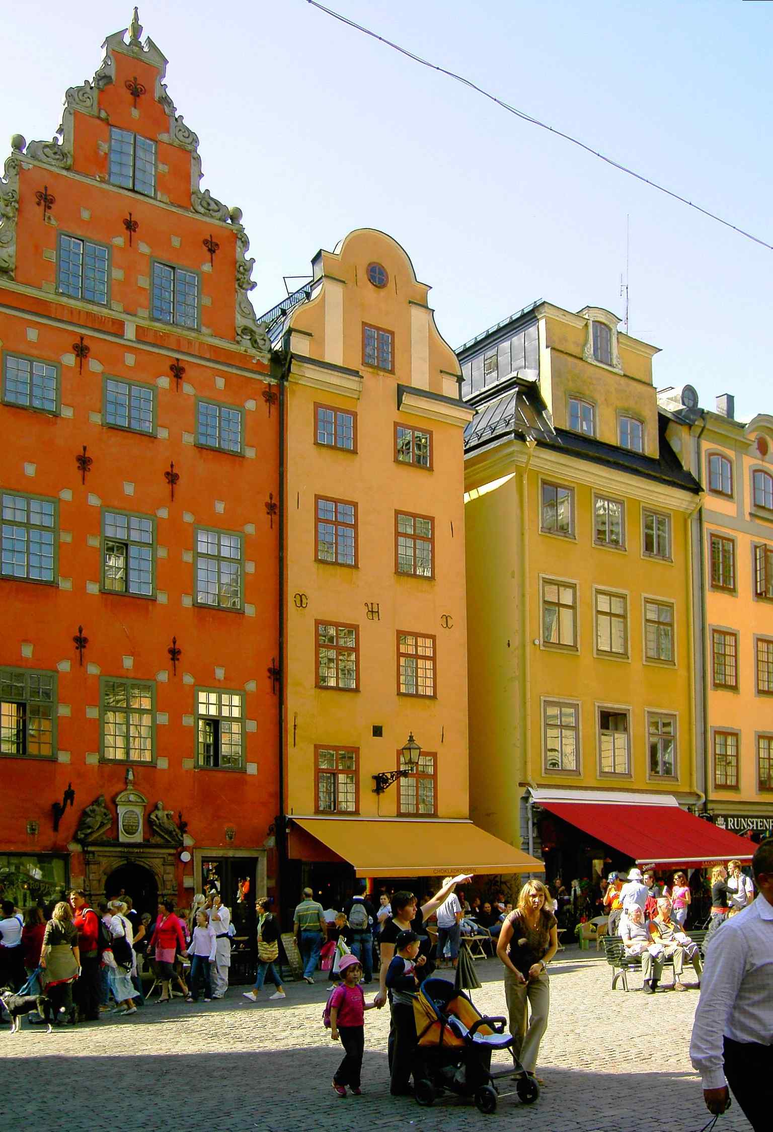 The striking Schantzska huset at Number 18-20, identifiable by its stepped gable and the 82 white stones, which local myth says represent the victims of the Stockholm Bloodbath.