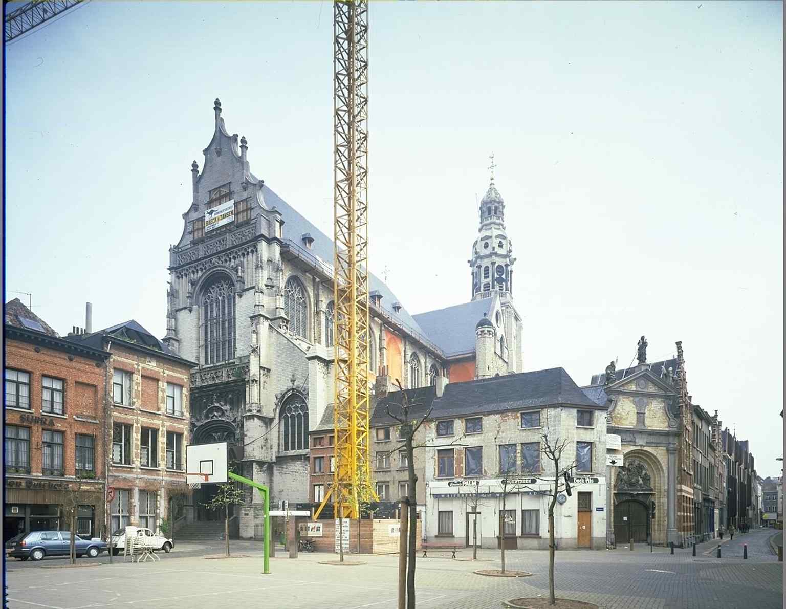 A strong full exterior view of the church on Veemarkt, showing the Gothic body and the later Baroque tower top that was finished after the 1679 fire.