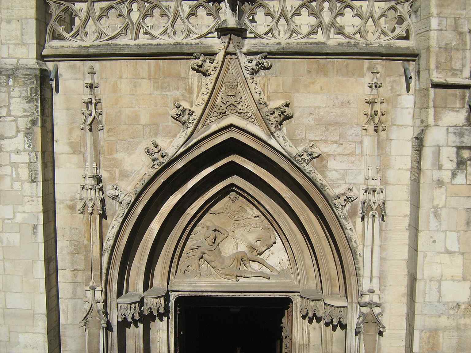 The west portal tympanum — a key decorative feature of the church’s entrance and an important piece of its medieval stonework.