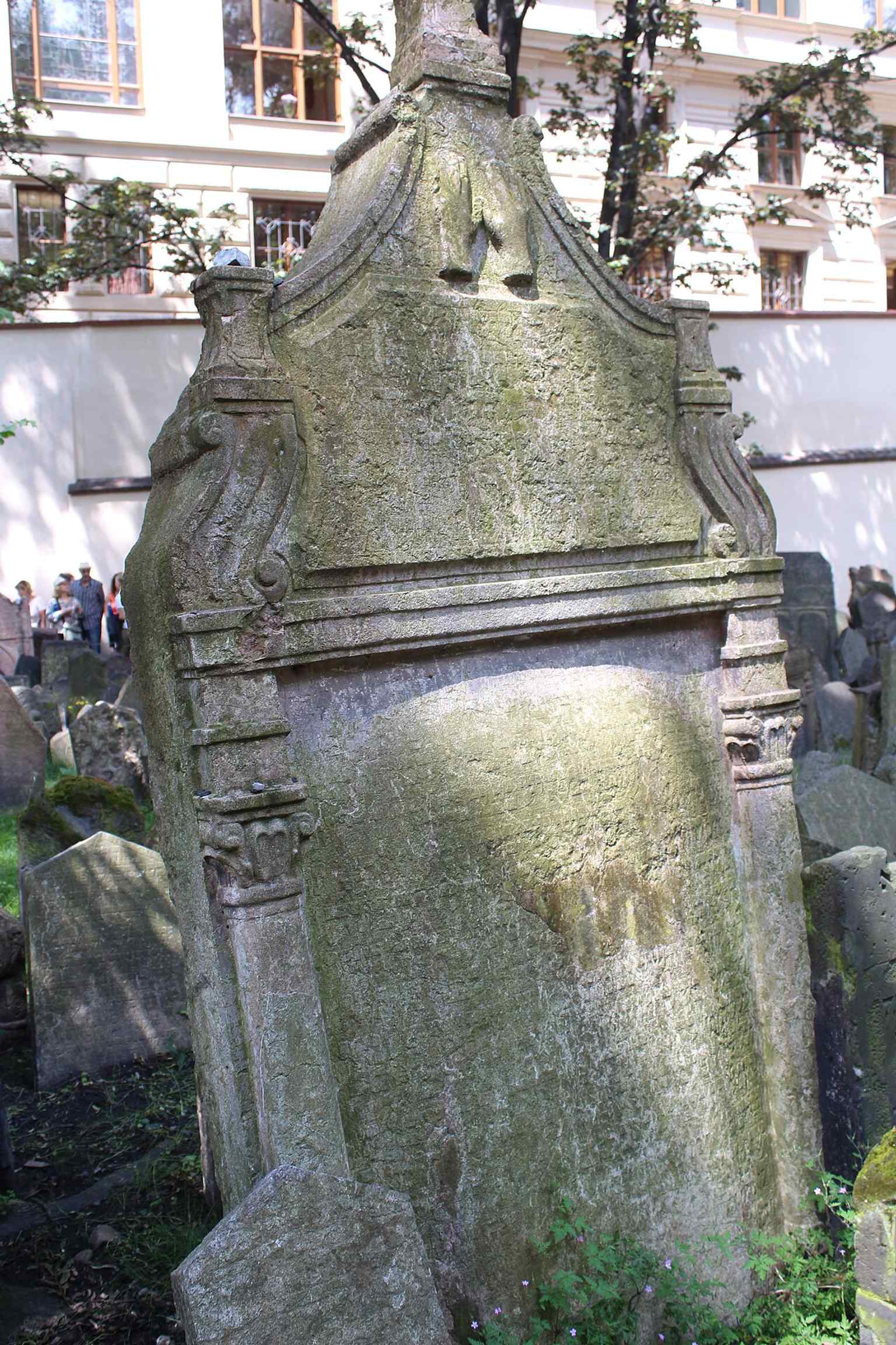 An example of diverse tombstones, showcasing the evolution of styles from simple slabs to four-sided tumbs and rich symbolic carvings like animals representing names or professions.