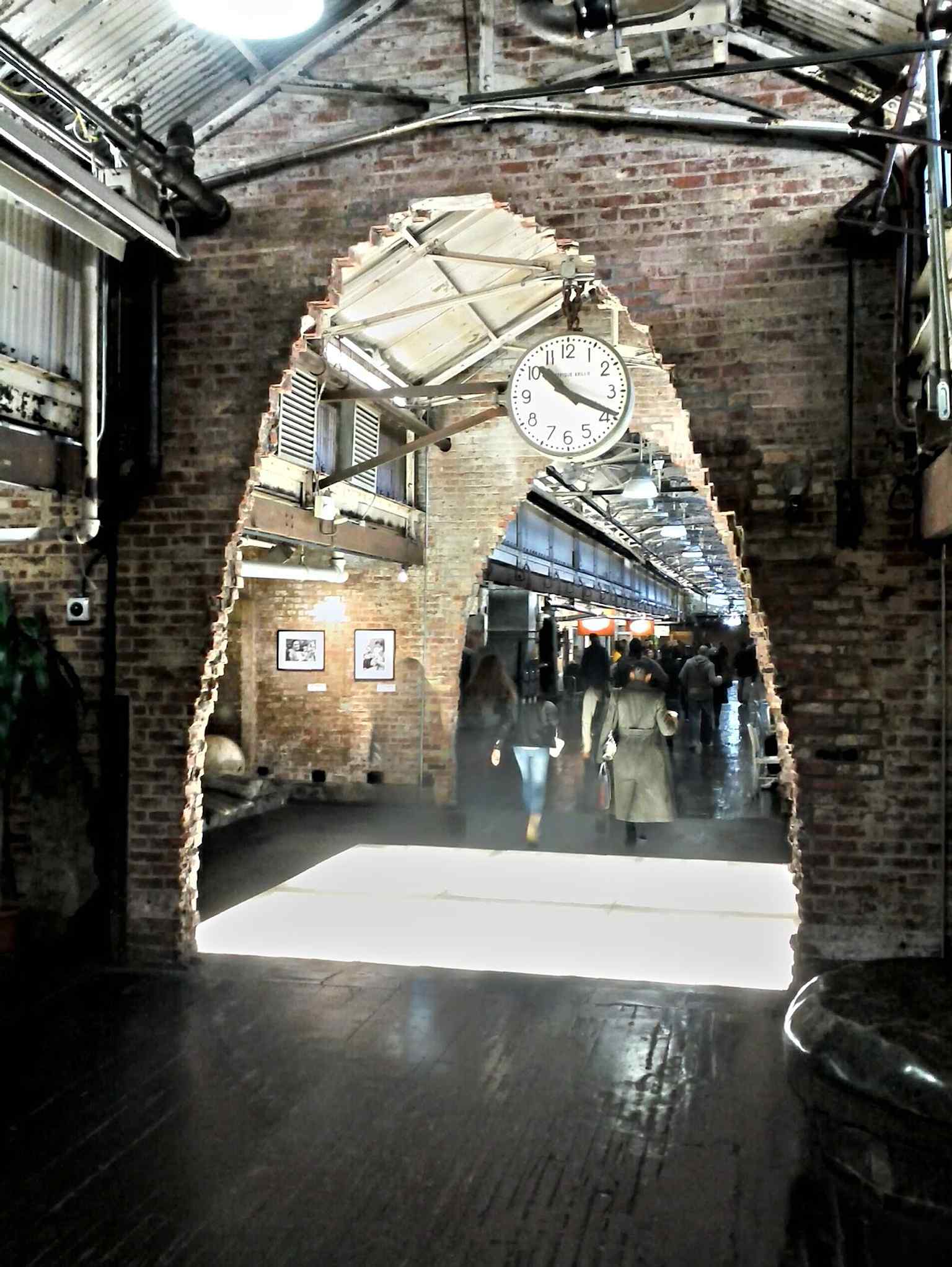 A brick archway inside the market’s main hall, part of the reused industrial architecture from the Nabisco era.
