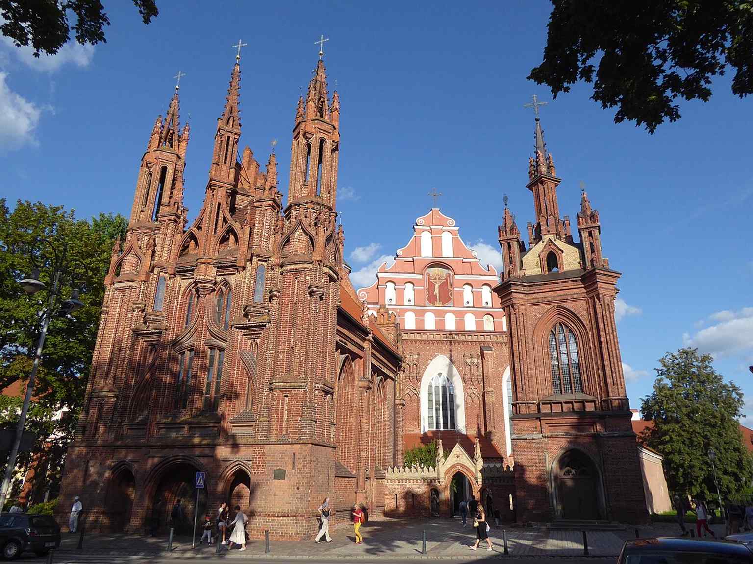 St. Anne’s Church in front with Bernardine Church behind it — the famous Vilnius ensemble the source text highlights as a unique Gothic pairing.