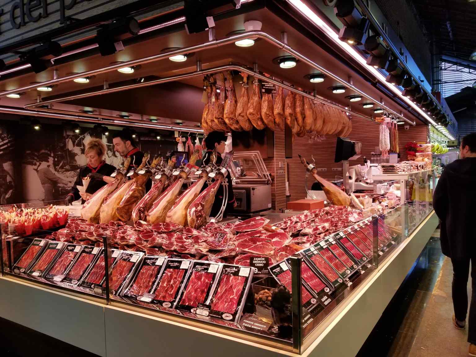 A butcher's stall reminiscent of the market's debated origin name, 'Boquería,' possibly derived from 'boc' (male goat), referring to early sales of goat meat.
