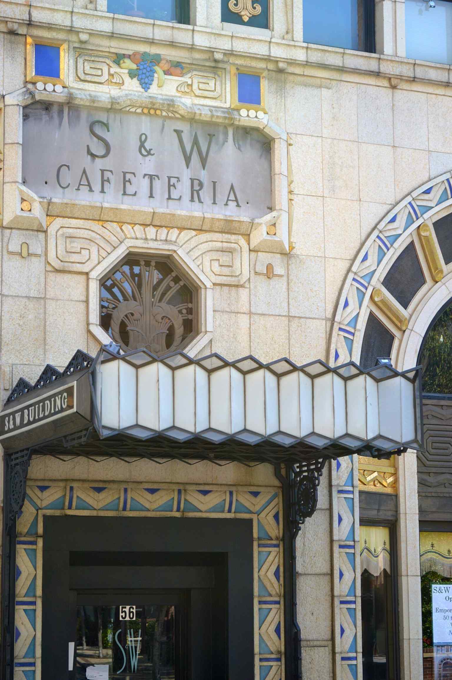 A full-height view of the Asheville landmark’s grey ashlar front, showing the building that moved from cafeteria to today’s S&W Market site.
