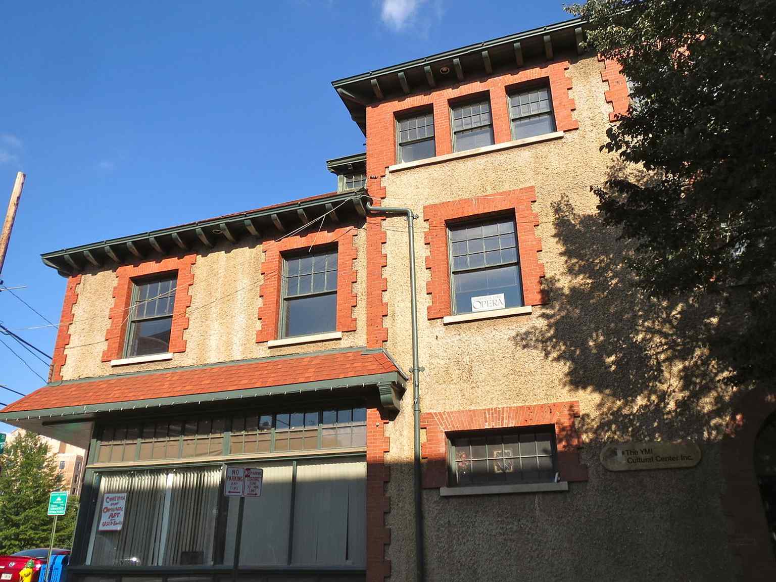 The YMI Building’s pebbledash façade and historic storefront level reflect its original role as a hub for Black-owned businesses and community life.