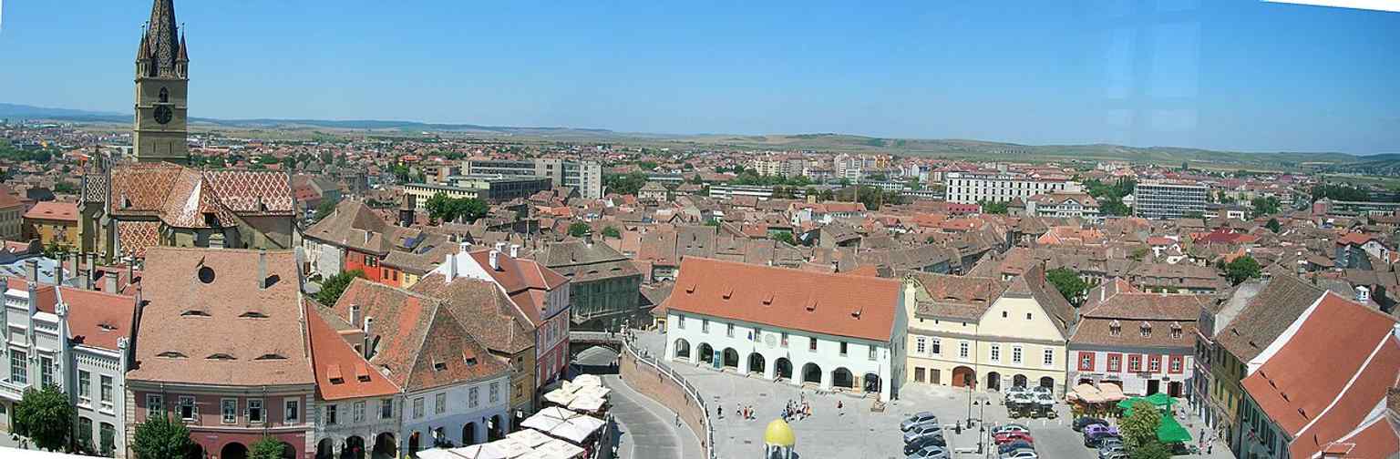This panoramic view from the Council Tower in Sibiu showcases the historic Casa Artelor, which houses the 'Emil Sigerus' Museum, in its prominent urban setting.