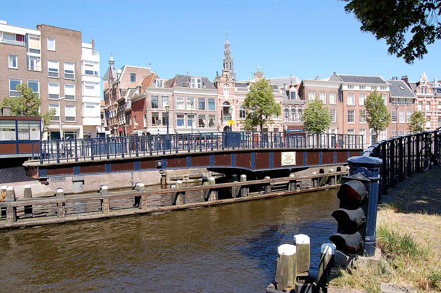 A clear daytime view of the Melkbrug, the historic Haarlem swing bridge that connects Hoogstraat and Korte Veerstraat.