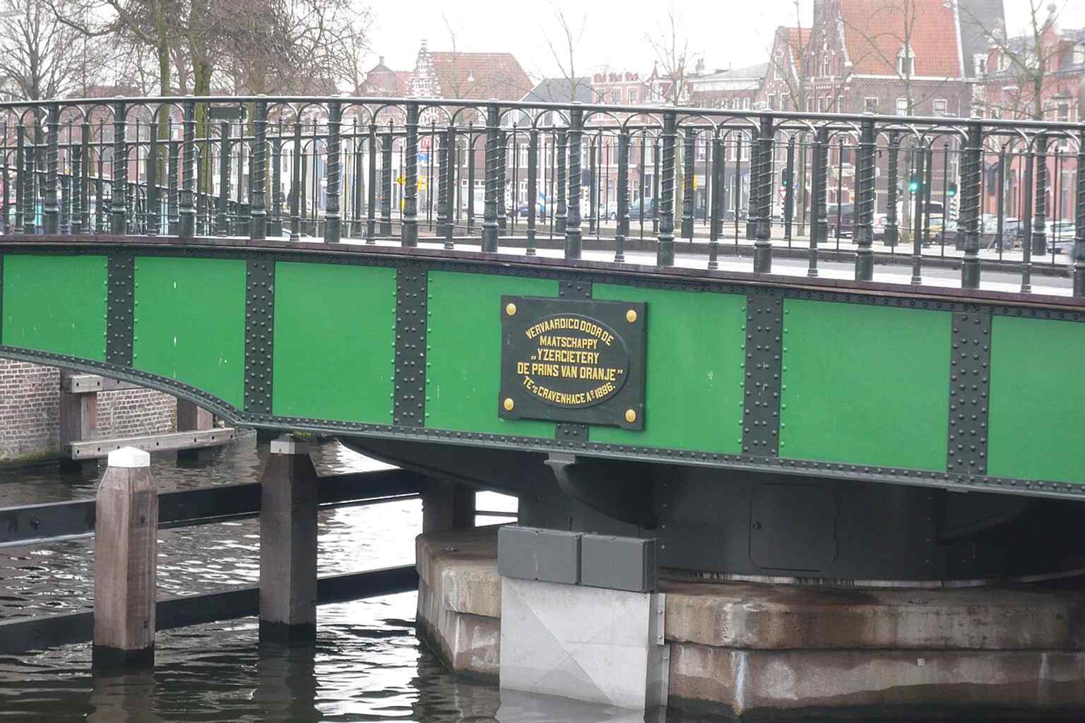 A close look at the restored bridge with plaques mentioning the Prins van Oranje ironworks, linking the structure to its 2010 restoration.