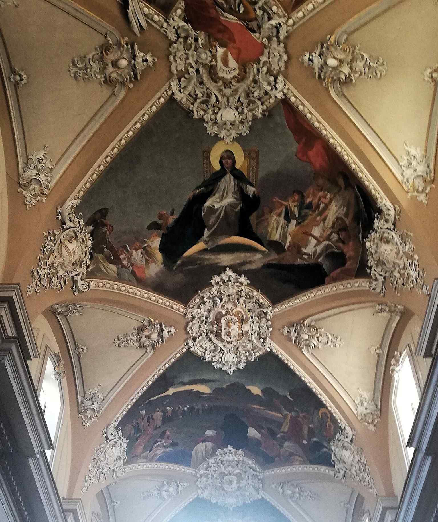 An interior view with the nave and altar area, evoking the basilica’s three-aisle plan and richly marbled sacred space.