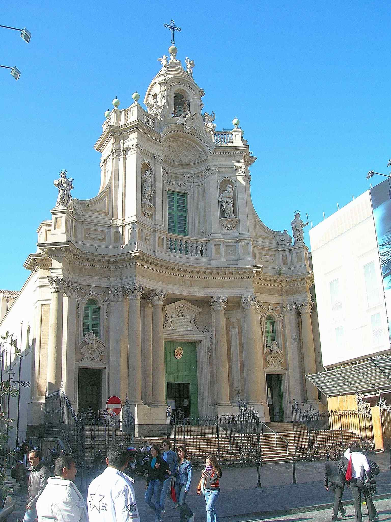 A tall view of the Collegiata’s façade and bell gables, ideal for the church’s monumental street presence.