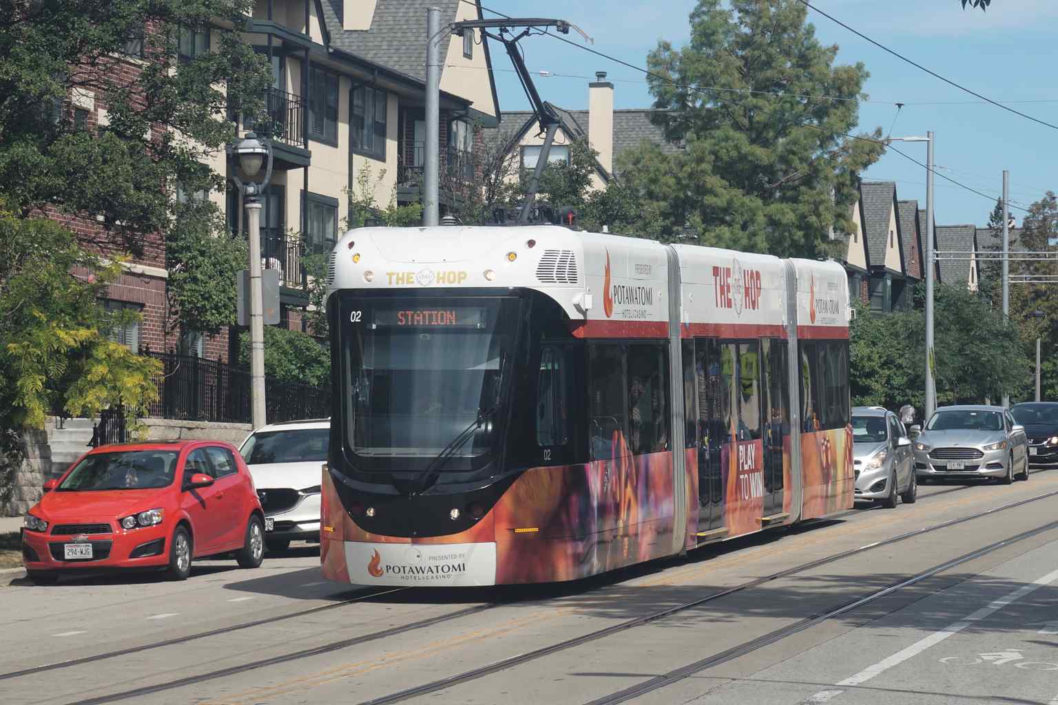 The Hop streetcar (Car 02) westbound on E. Ogden Avenue, part of the 2.1-mile M-Line that connects major Milwaukee neighborhoods.