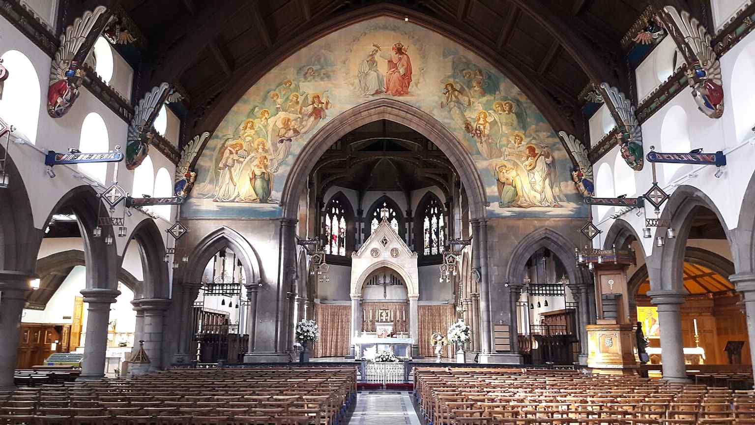 A wide interior view that captures the cathedral’s ornate nave and the rebuilt Victorian/20th-century atmosphere inside.