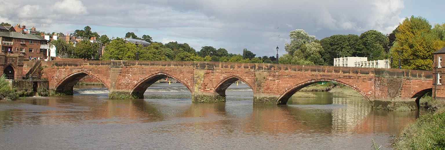 A wider river view that captures the whole bridge span, helping explain how it crosses the Dee and once served the city’s approach.