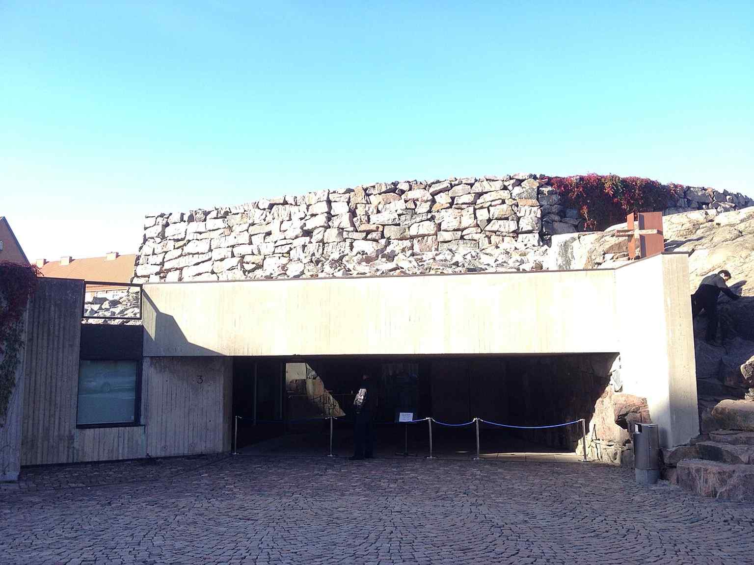 The church entrance at street level — a reminder that visitors step down from the city into a sanctuary carved directly into bedrock.