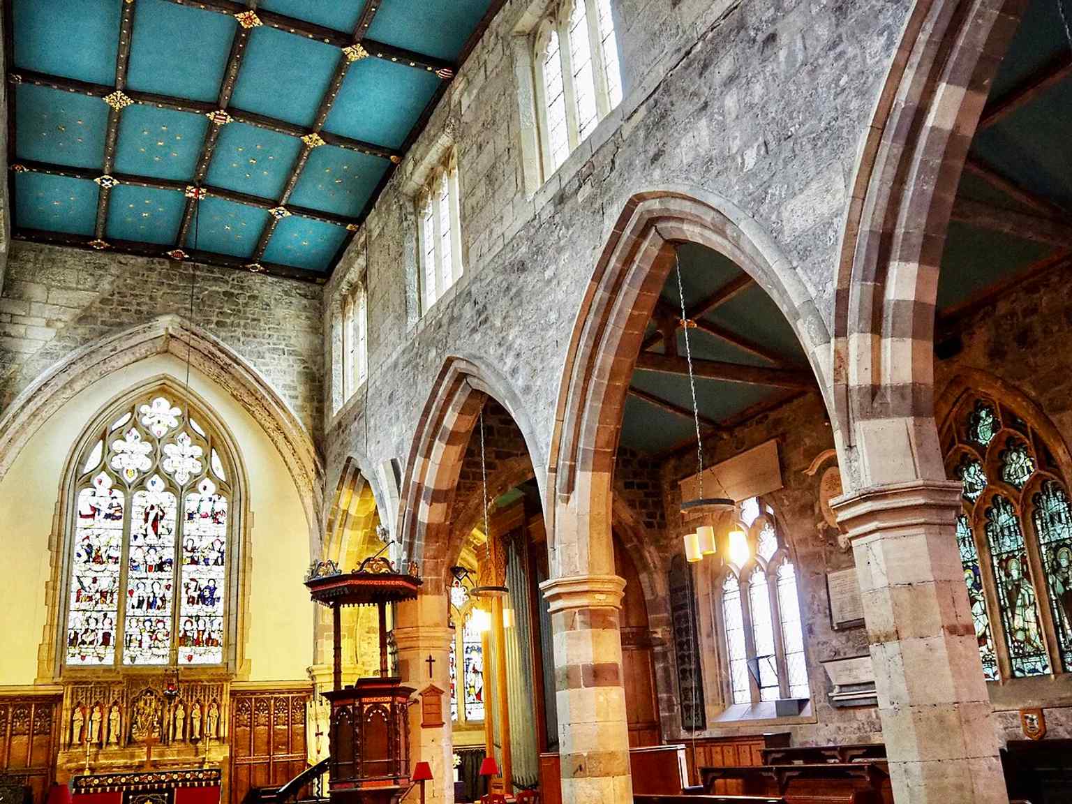 A wide interior view of the nave, where Victorian changes replaced the old box pews in 1848.
