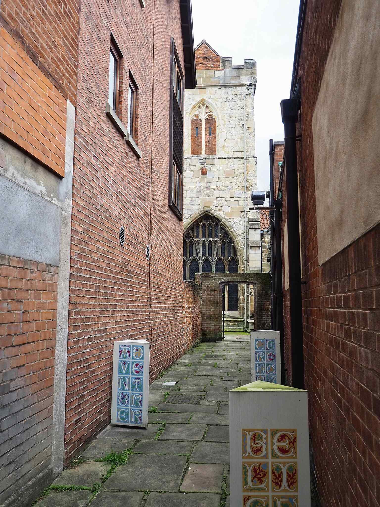 A clear view of Holy Trinity from Hornpot Lane, showing the Grade I medieval church hidden among later York streets.