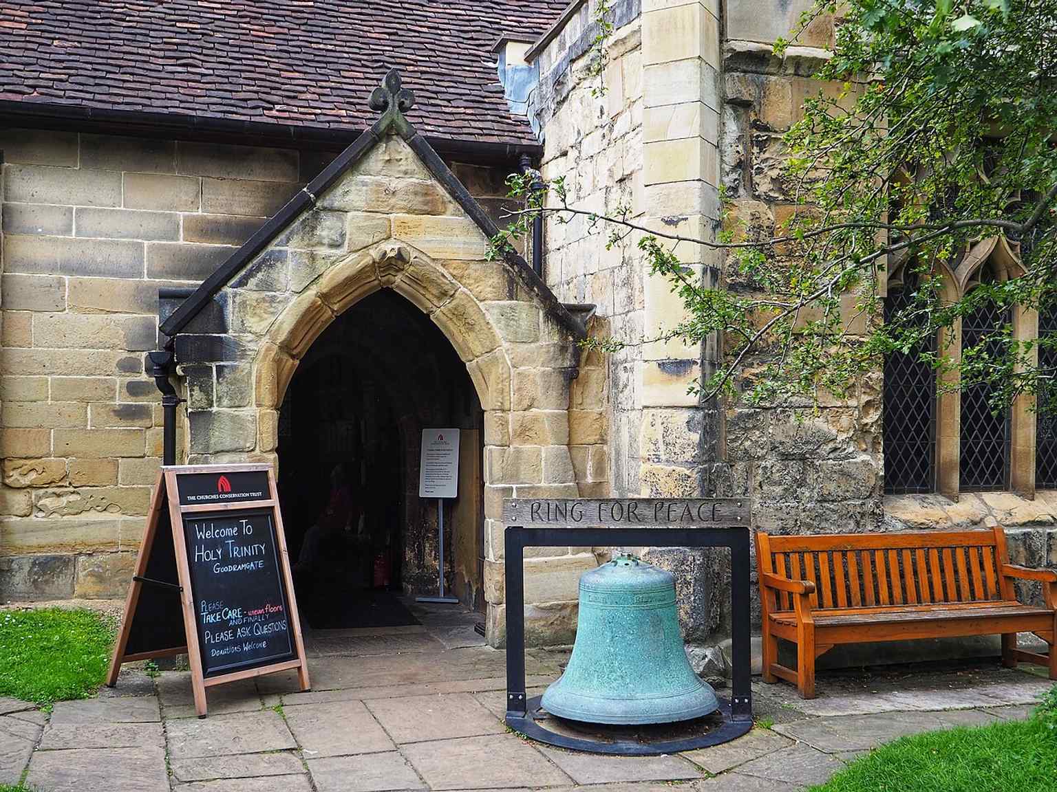 The church exterior with its layered stonework and later additions, reflecting centuries of change from the 12th century onward.