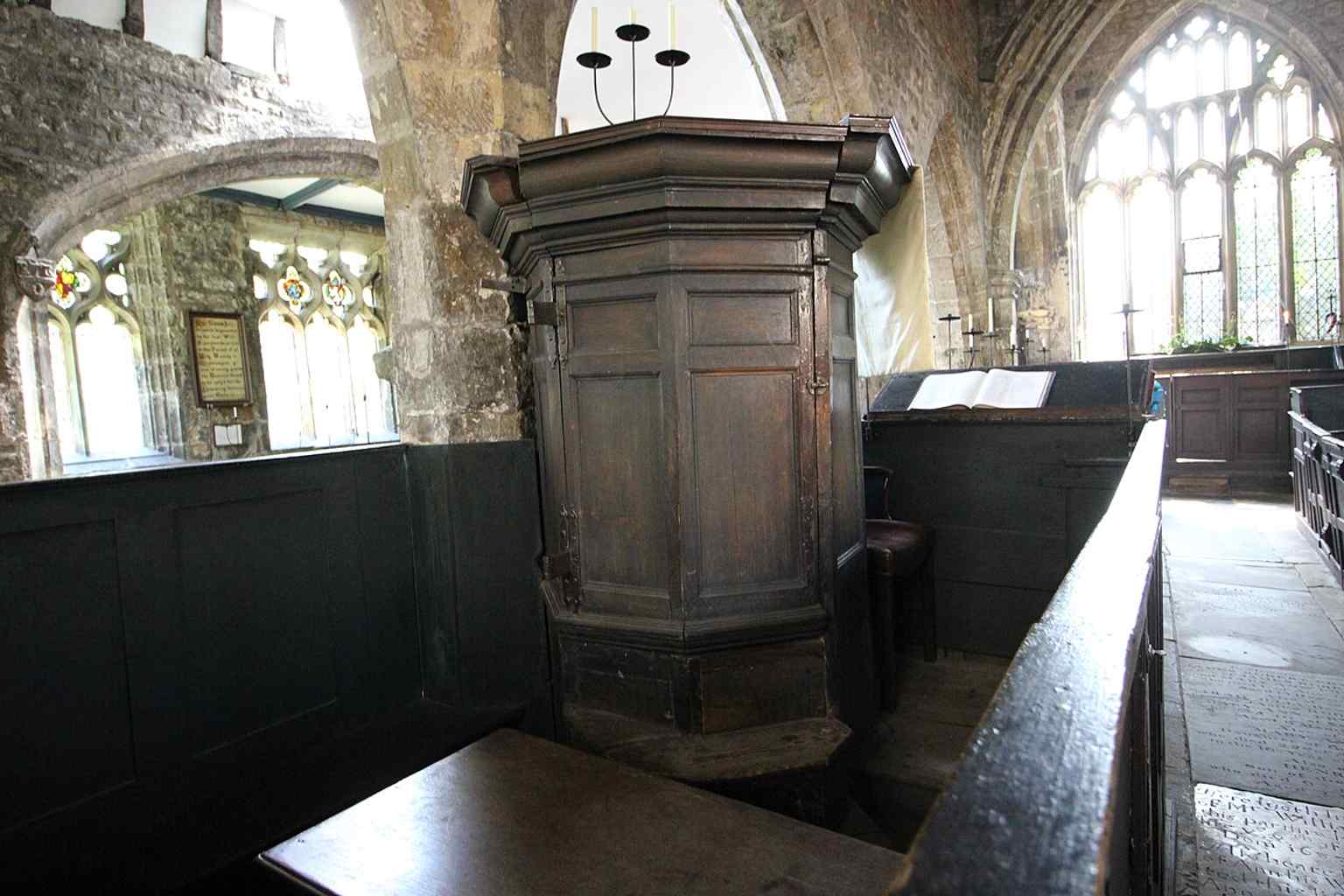 The pulpit inside the church, one of the surviving fittings that helps preserve its unusual historic interior.