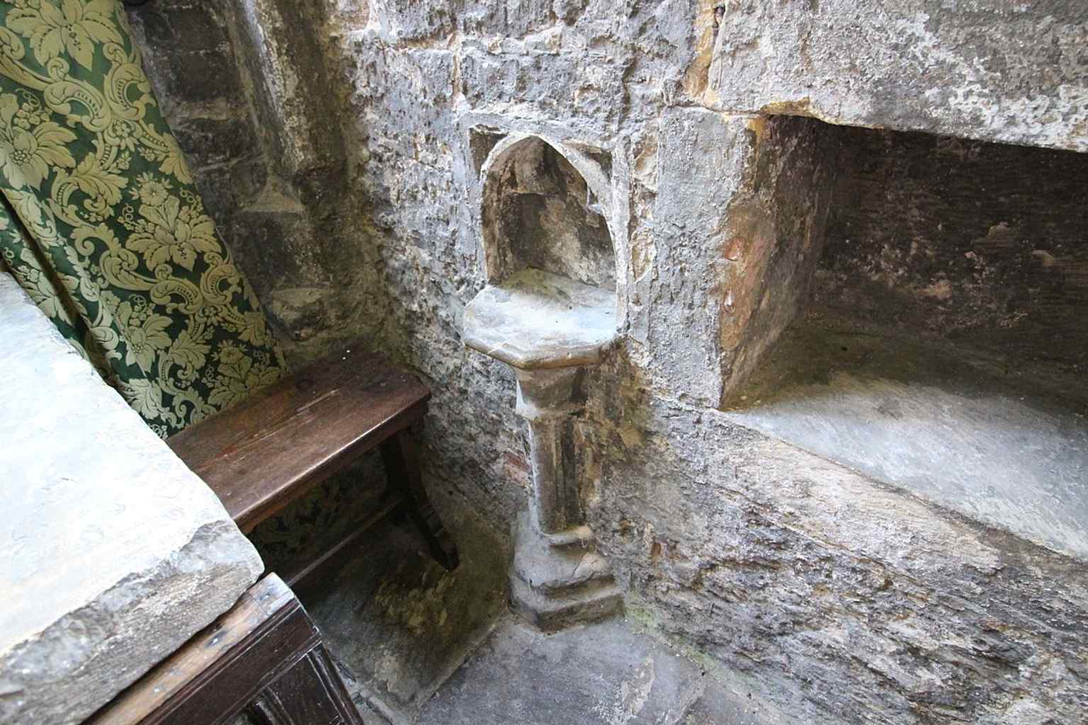 A medieval piscina in the church, a small liturgical feature that speaks to the building’s long pre-Reformation history.