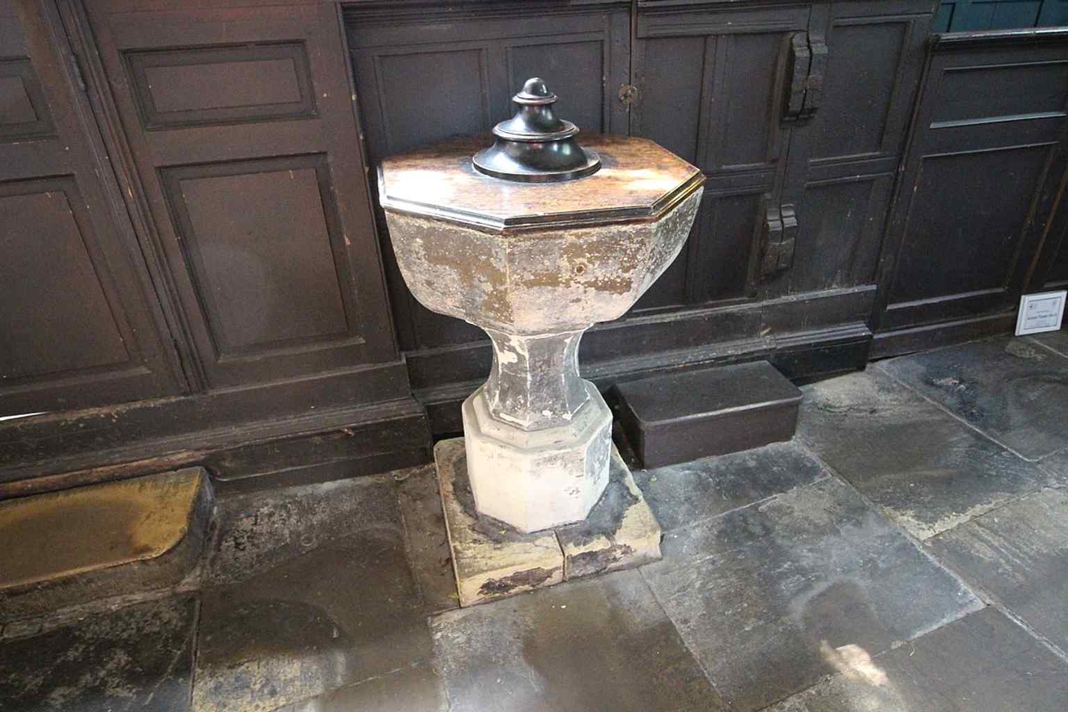 The font and interior fabric of Holy Trinity, part of the surviving parish church fittings that connect today’s visit to centuries of baptisms.