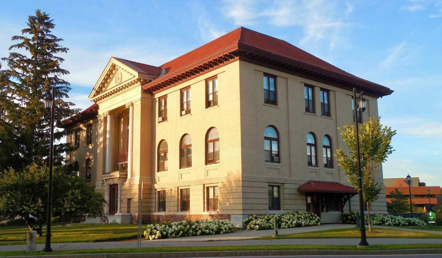 The main entrance features two massive granite columns, donated by Senator Morrill's son, and is topped with a pediment adorned with the Great Seal of Vermont.