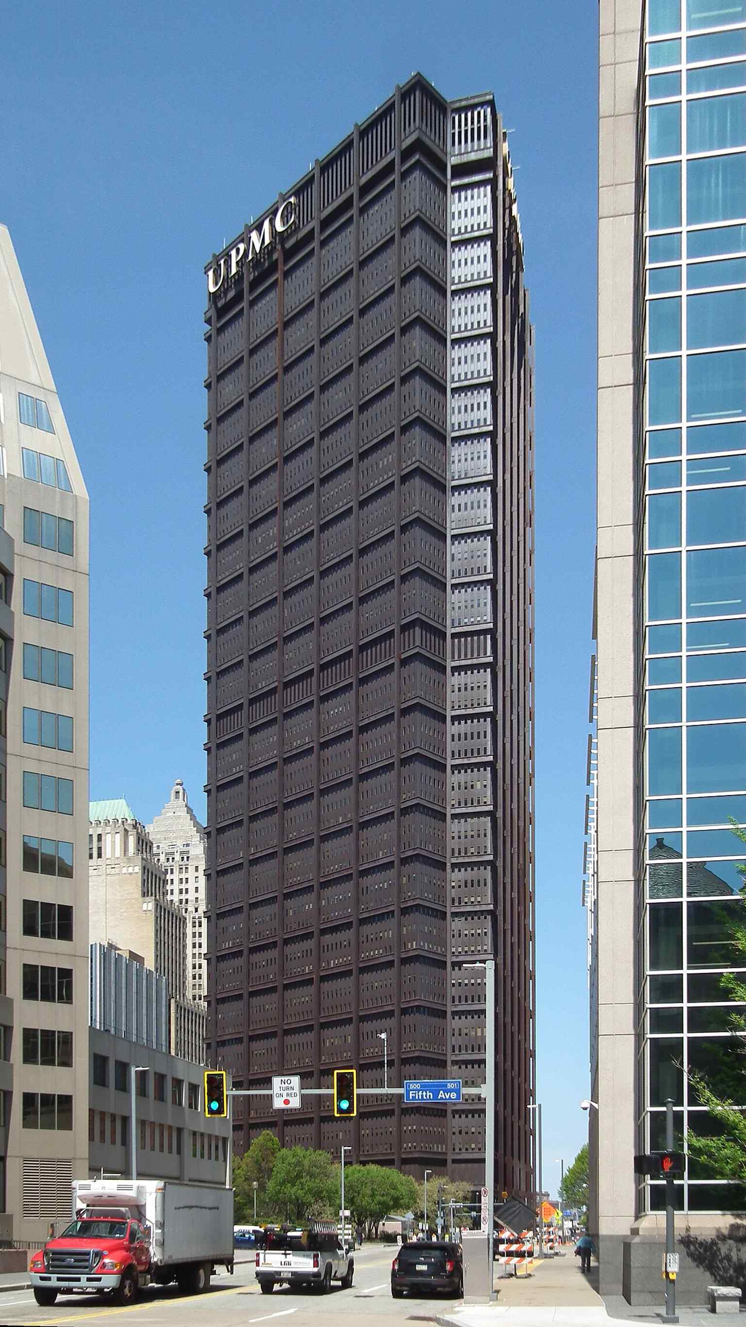 A dramatic vertical shot of the U.S. Steel Tower from Ross Street accentuates its immense height and the sleek, modern lines of its construction, which utilized over 44,000 tons of structural steel.