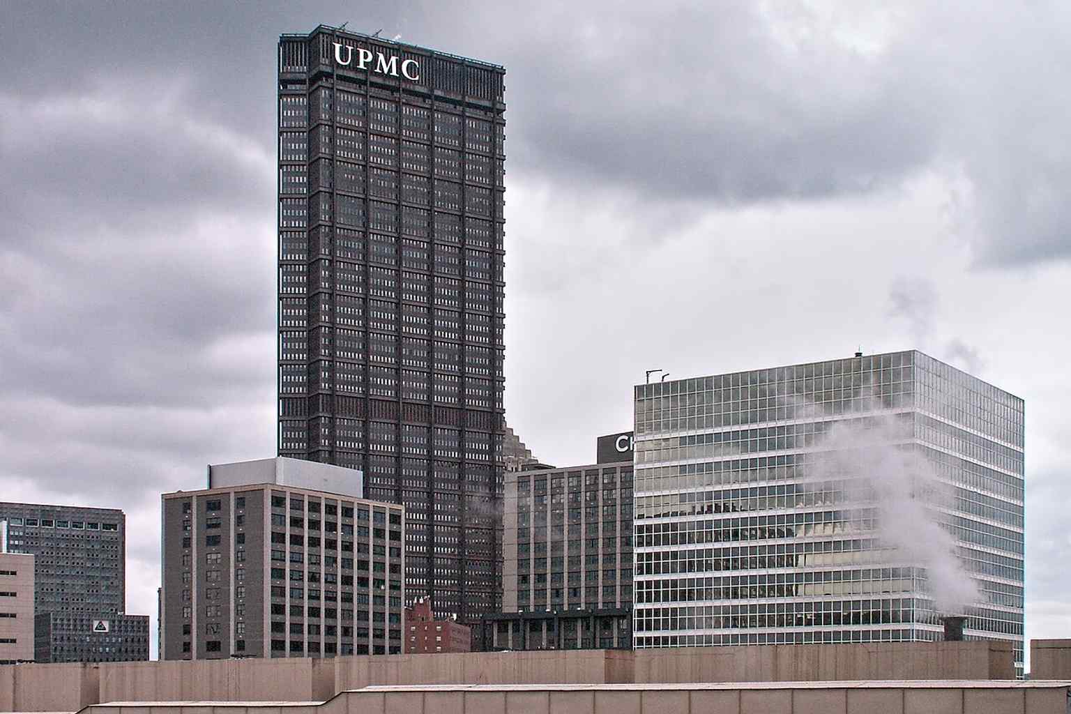 The U.S. Steel Tower stands prominently alongside the Chatham Center, viewed from Duquesne University, illustrating its commanding integration into the dynamic downtown Pittsburgh urban landscape.