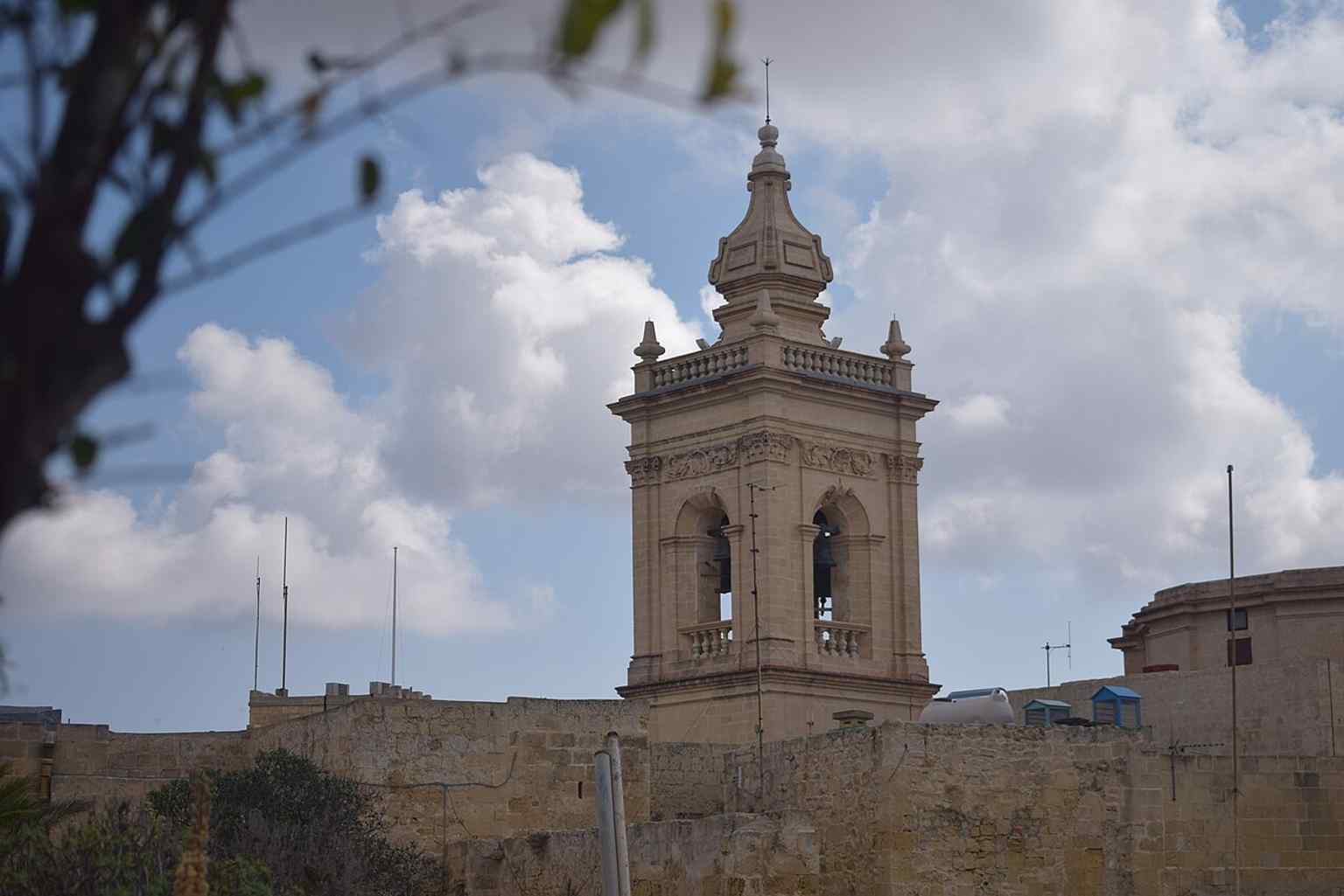 The bell tower on the north-east side, one of the cathedral’s most recognisable exterior features in the Cittadella skyline.