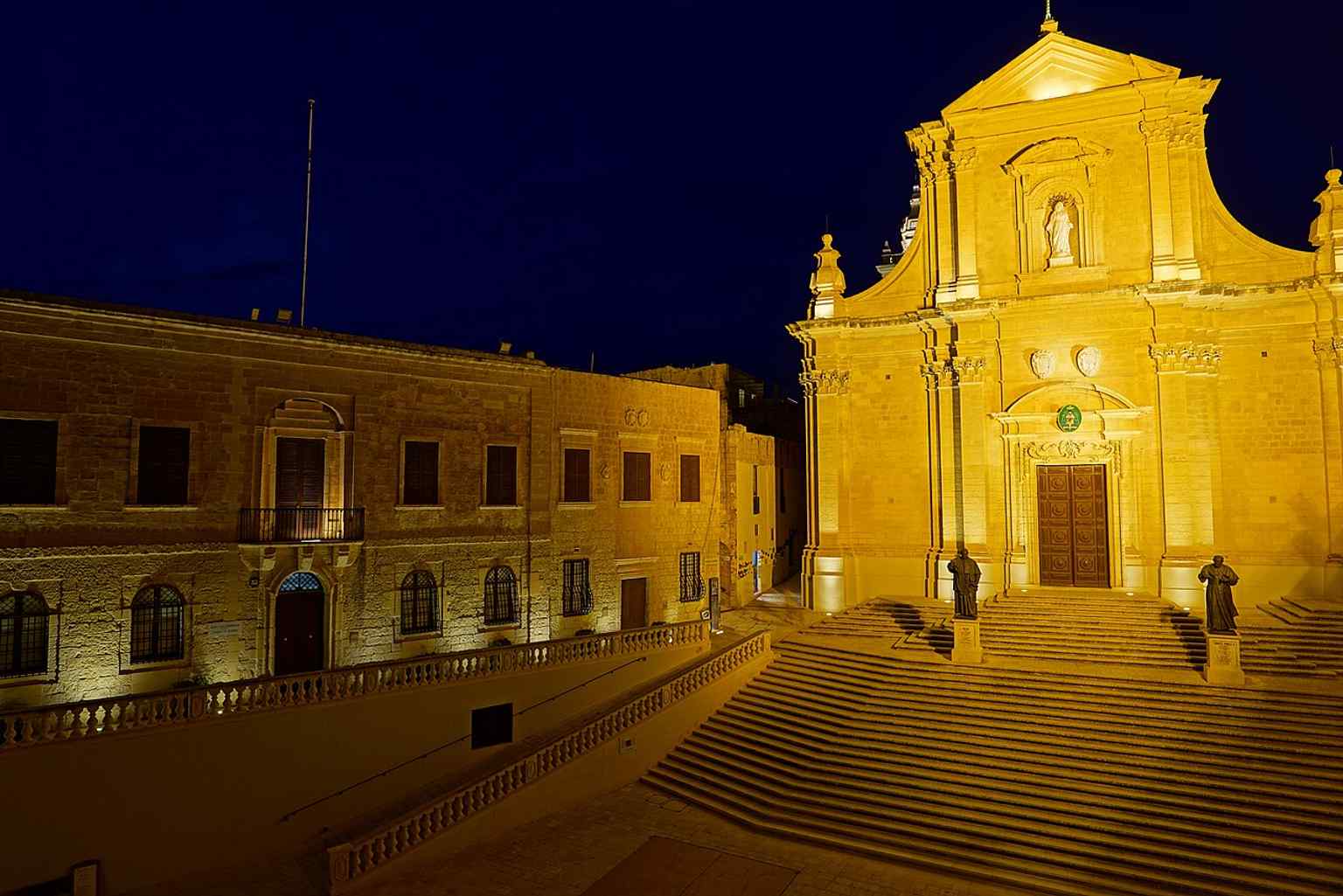 The cathedral beside the Citadella law courts, a good context shot for how the church sits within Gozo’s fortified civic core.