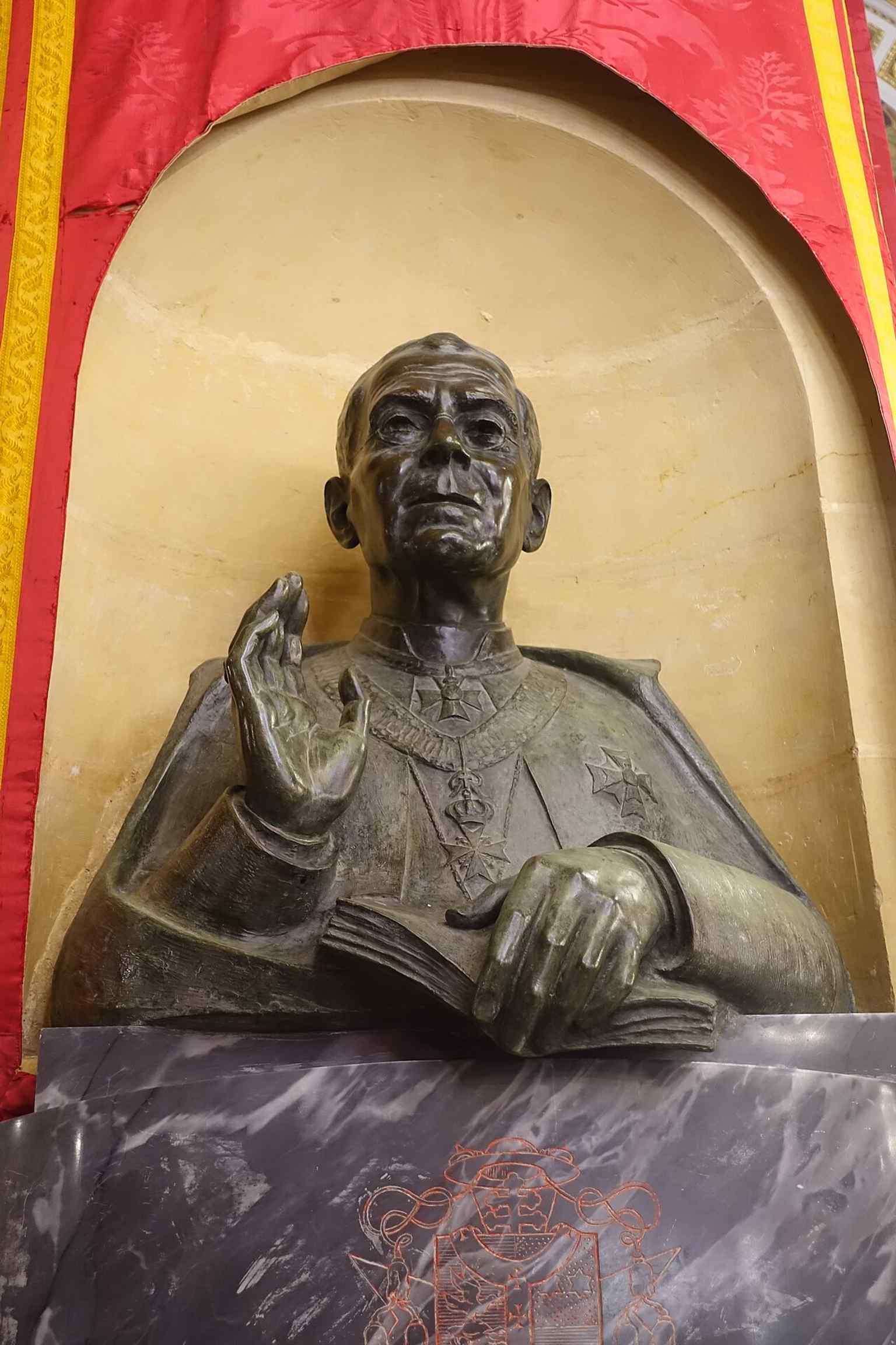 The bust of Bishop Pietro Pace inside the cathedral, reflecting its later role as the seat of the Diocese of Gozo from 1864.