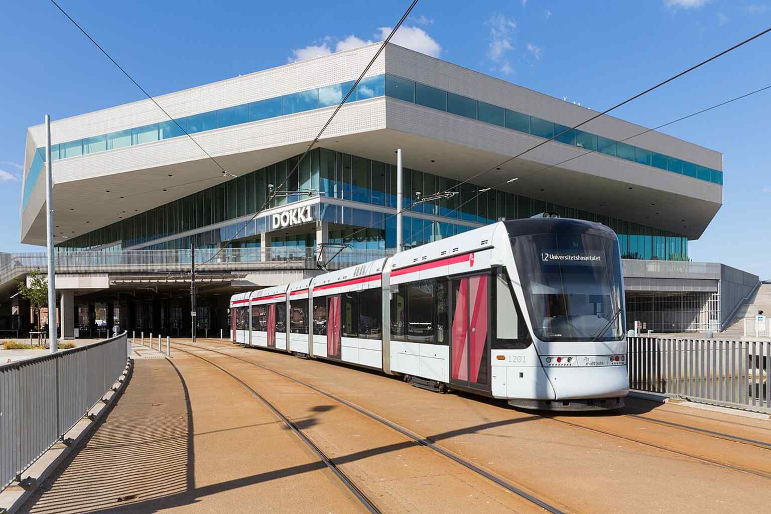 A tram approaching Dokk1 — the light rail connection runs through this landmark building and links it directly to the city.