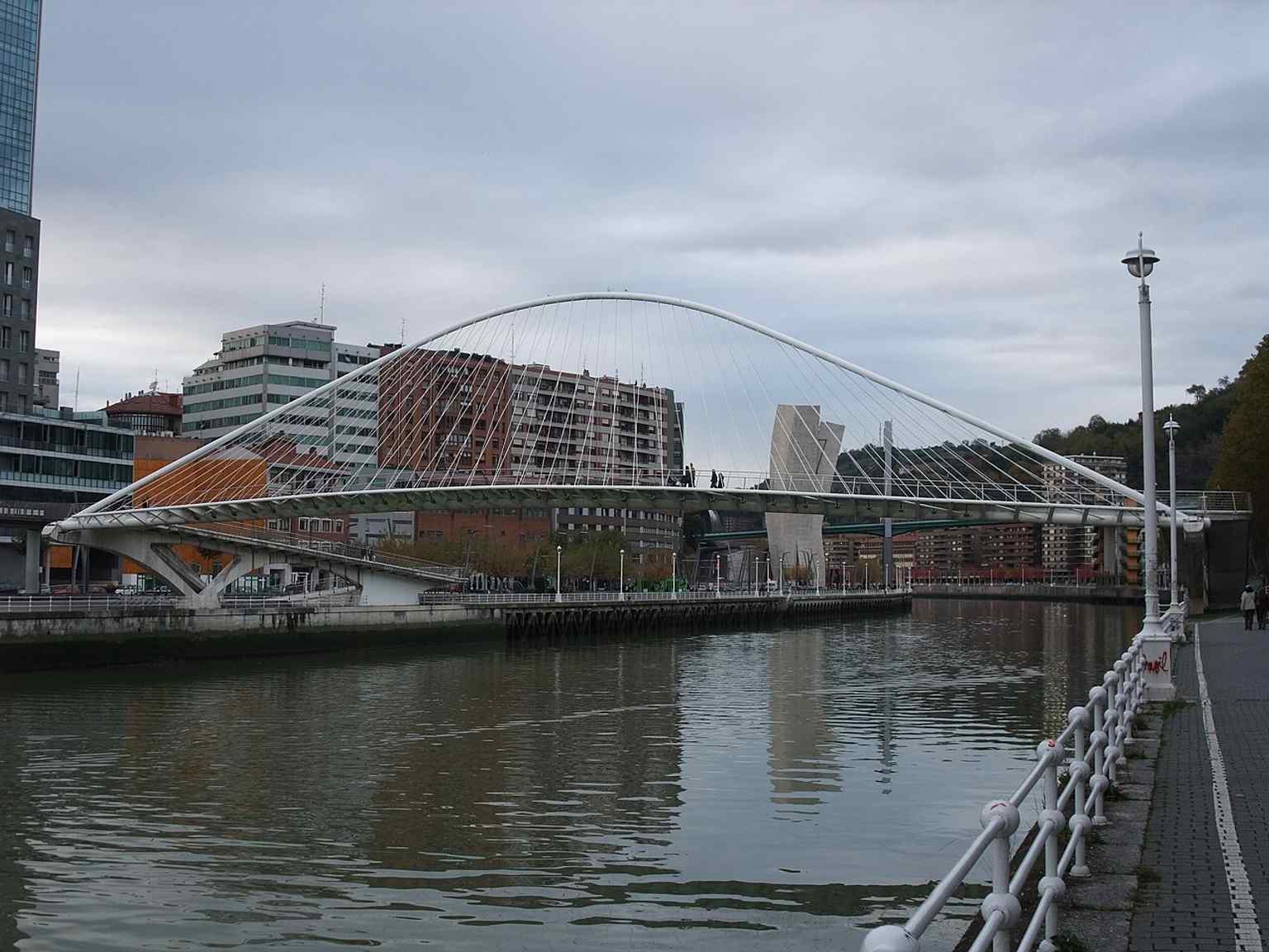 The bridge in full daylight, with its sweeping white arch making Zubizuri a symbol of Bilbao’s modern riverfront.